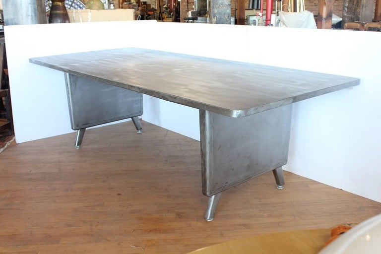 Large Machine Age metal desk/dining table. Space between legs 61.75