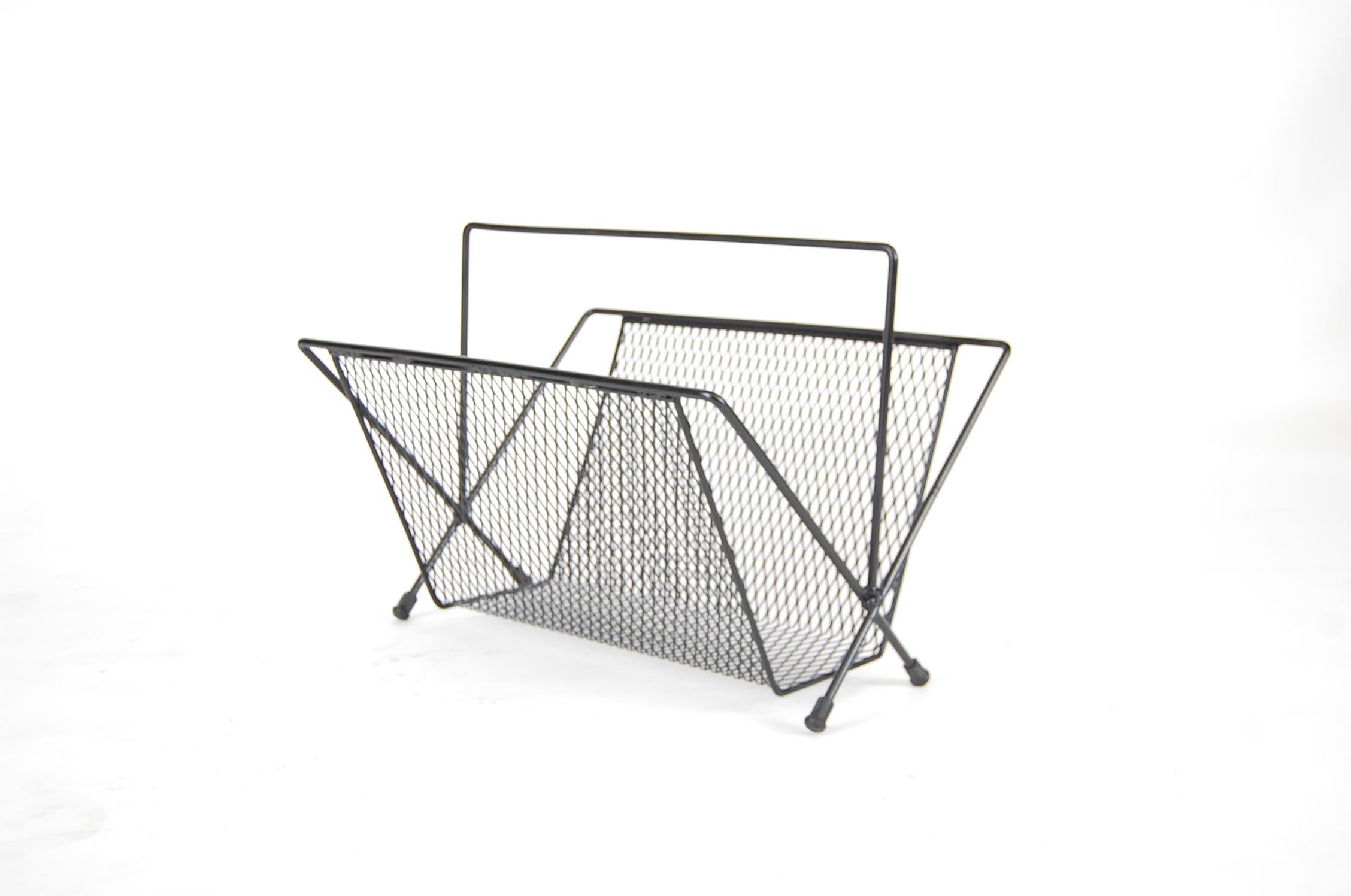 Large magazine rack in the manner of Mathieu Matégot, circa 1955. Most likely American. Constructed of steel rod, perforated steel sheeting, and has rubber boots. Measures: 22 1/4