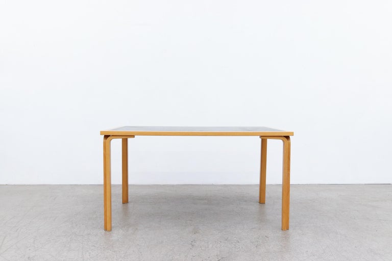 Mid-Century Magnus Olesen Dining Table by Rud Thygesen & Johnny Sørensen with Bent Birch Legs and Black Formica Inset Top. In Original Condition with Visible Wear including some staining to the Inset Formica, and Wear to the Frame. Wear is