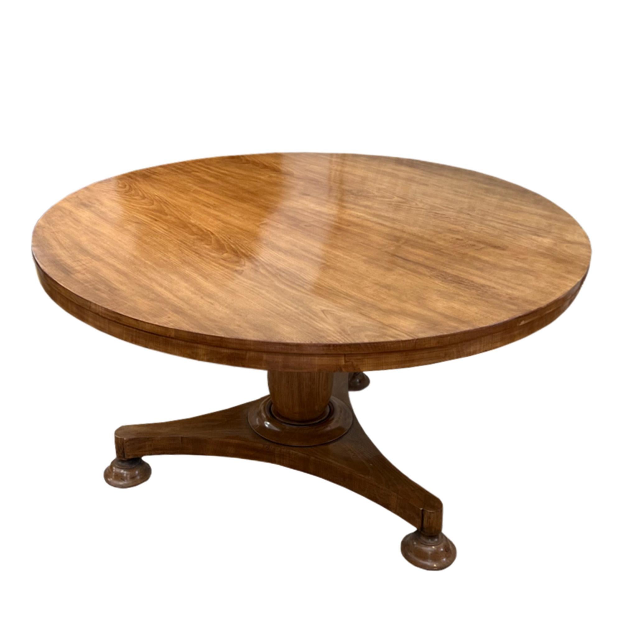 This is a gorgeous English 19th century breakfast table made from beautiful pale mahogany wood. A large centre table, it rests on a tripod stand. The top can also be flipped as seen in a photo below which allows it to be easily moved and assembled.