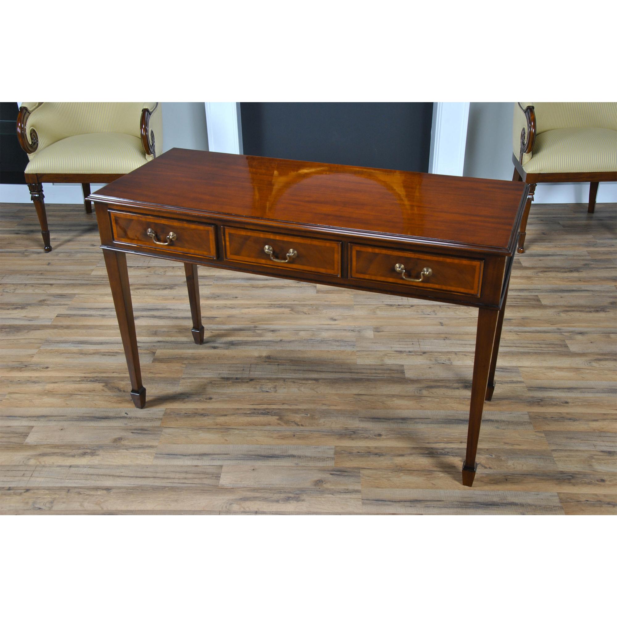 A gorgeous Large Mahogany Banded Console made of mahogany and satinwood with solid brass drawer pulls. The three dovetailed drawers denote high quality construction and the elegant tapered legs end in a popular spade foot design. The Large Mahogany