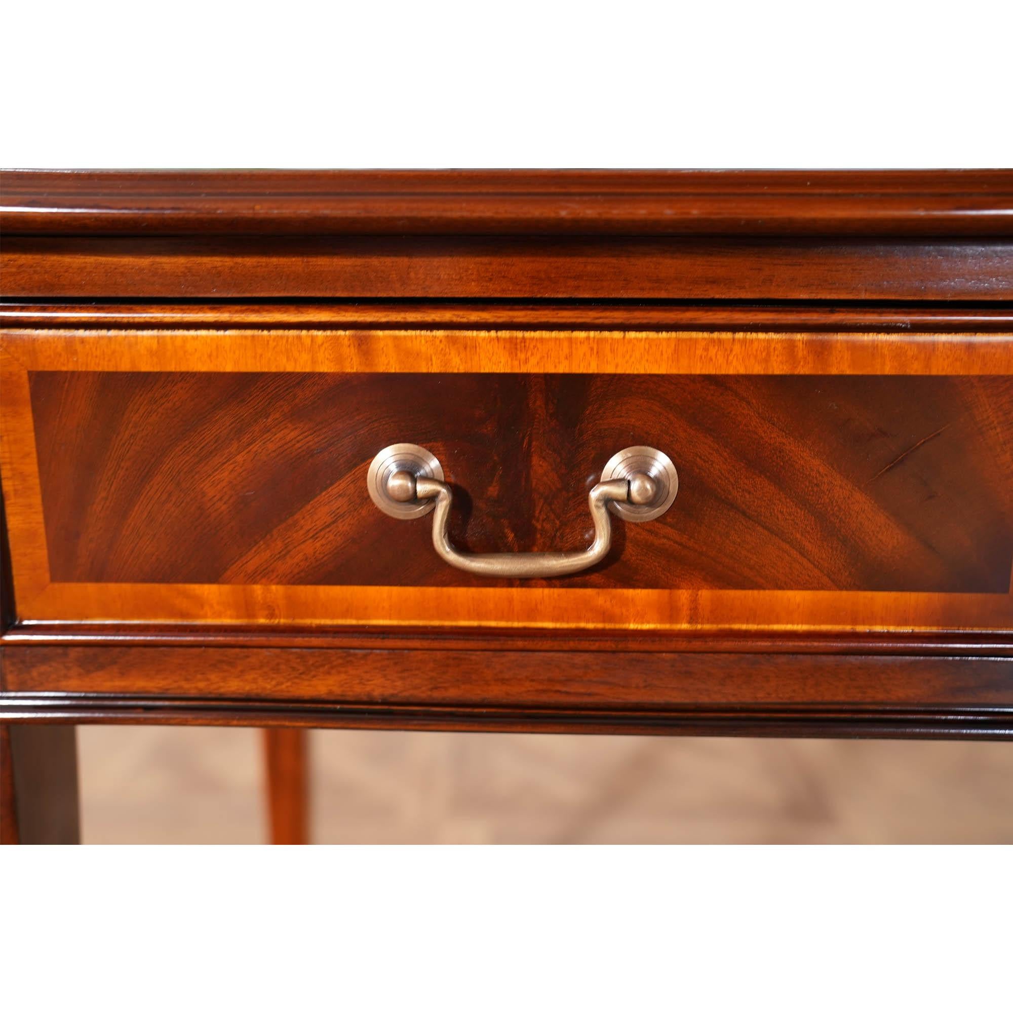 A gorgeous Large Mahogany Banded Console made of mahogany and satinwood with solid brass drawer pulls. The three dovetailed drawers denote high quality construction and the elegant tapered legs end in a popular spade foot design. The Large Mahogany
