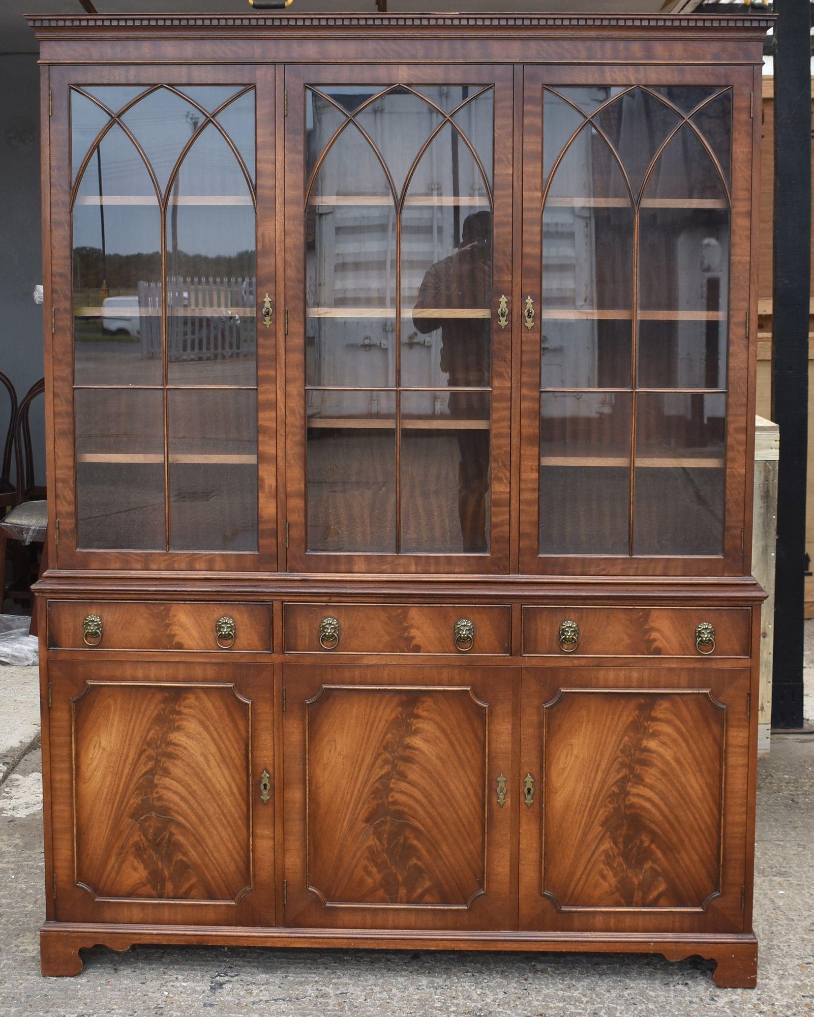 Large Mahogany Glazed Bookcase
Item Code: 1216
An impressive bookcase in mahogany, designed in the Georgian style. The piece features three tall glazed doors with elegant Gothic arch astragals above a row of drawers and panelled cupboard doors