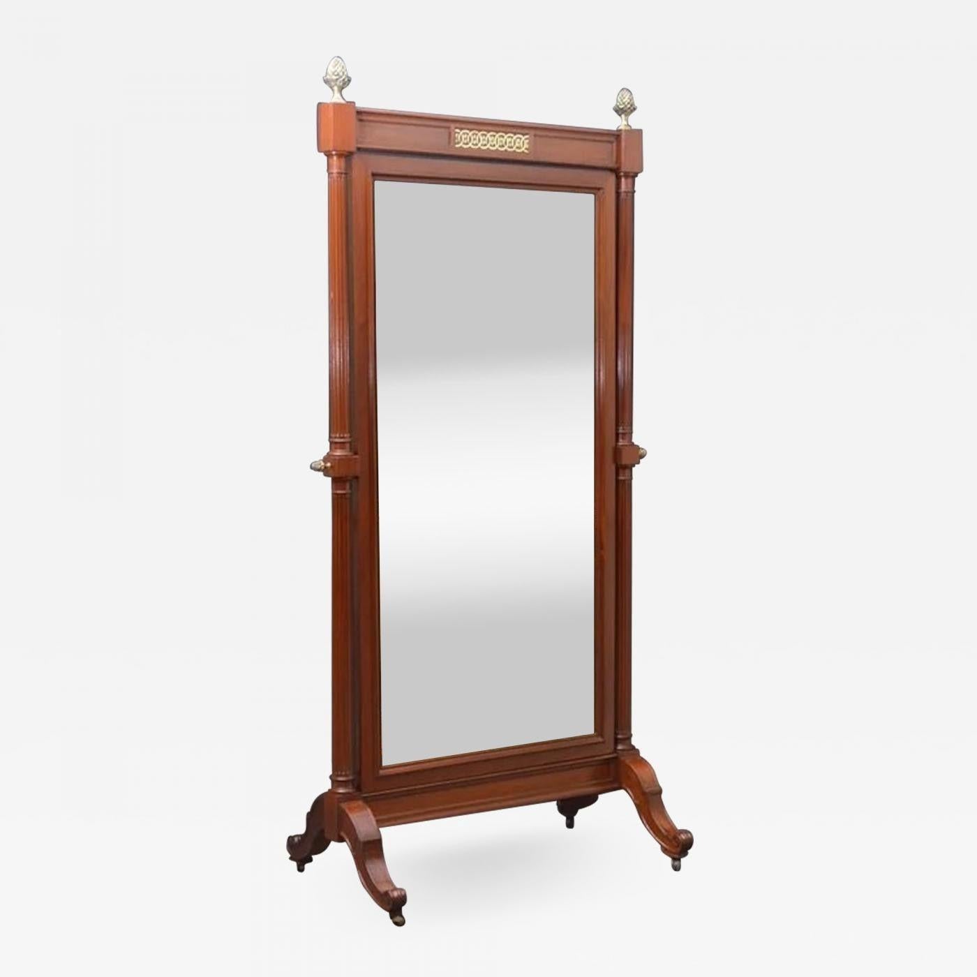 Sn4050 A superb quality solid mahogany French cheval mirror of elegant design, having original mirror plate with some foxing in moulded frame and turned and fluted supports with fantastic quality brass pineapple finials to top united by brass