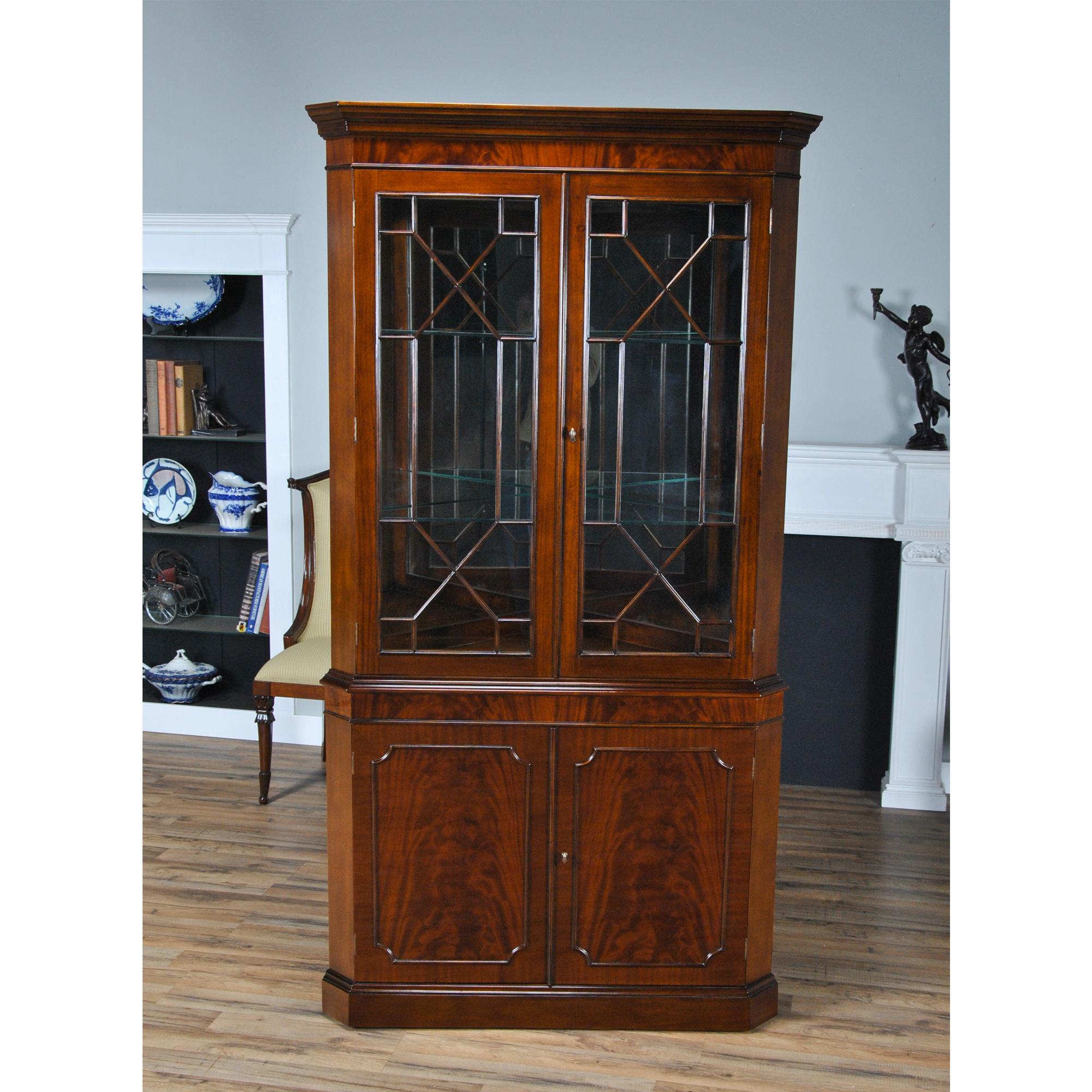 This double door, Large Mahogany Corner Closet is manufactured from kiln dried, plantation grown, mahogany, and features figured mahogany veneers on the door fronts. The attention to detail and expert craftsmanship is apparent in the hand carved