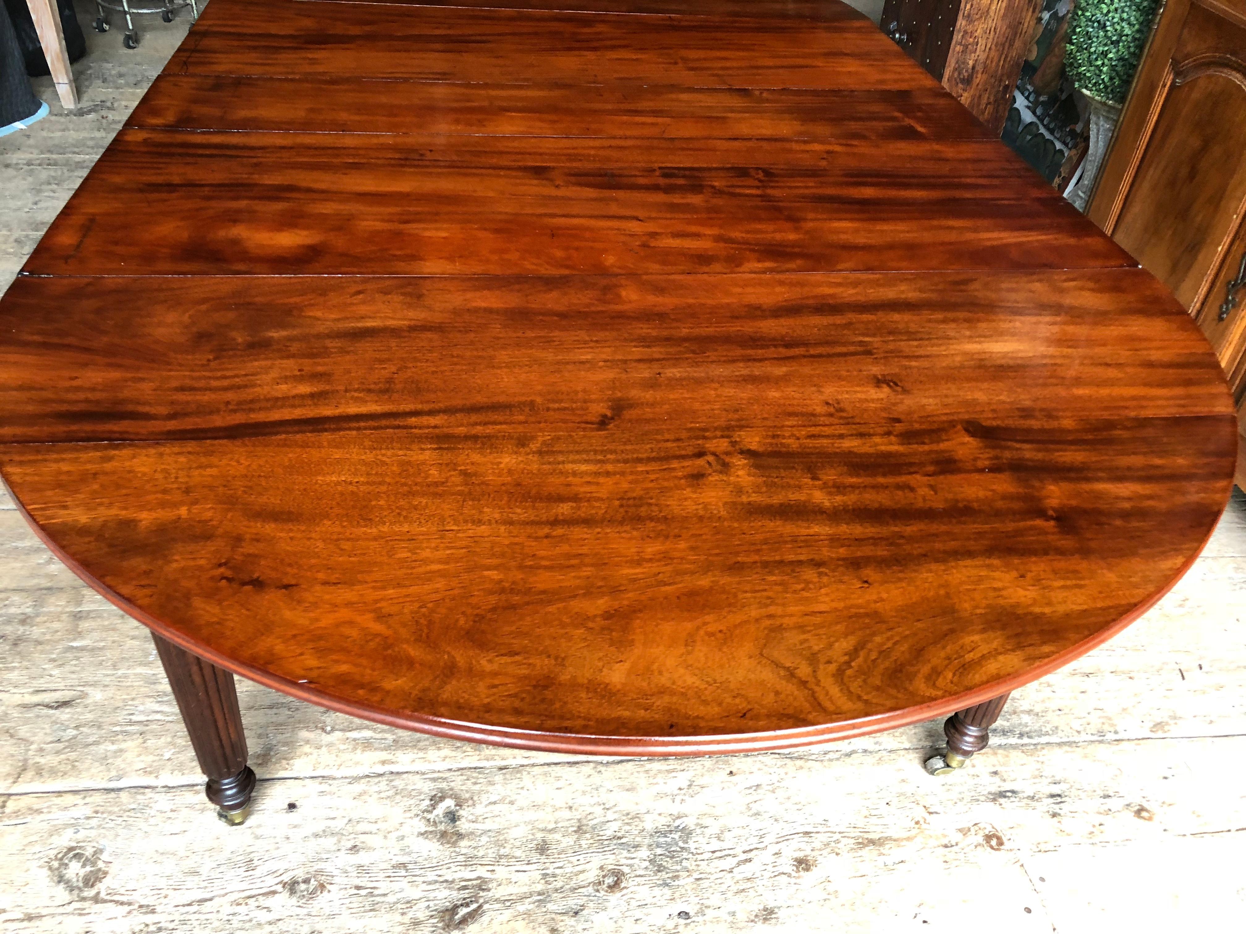A large expandable French Louis Philippe period drop-leaf dining table in solid mahogany (not veneer) with three additional leaves allowing for seating for 14.
The Cuban mahogany top rests on an oak mechanism that opens and closes easily. The legs