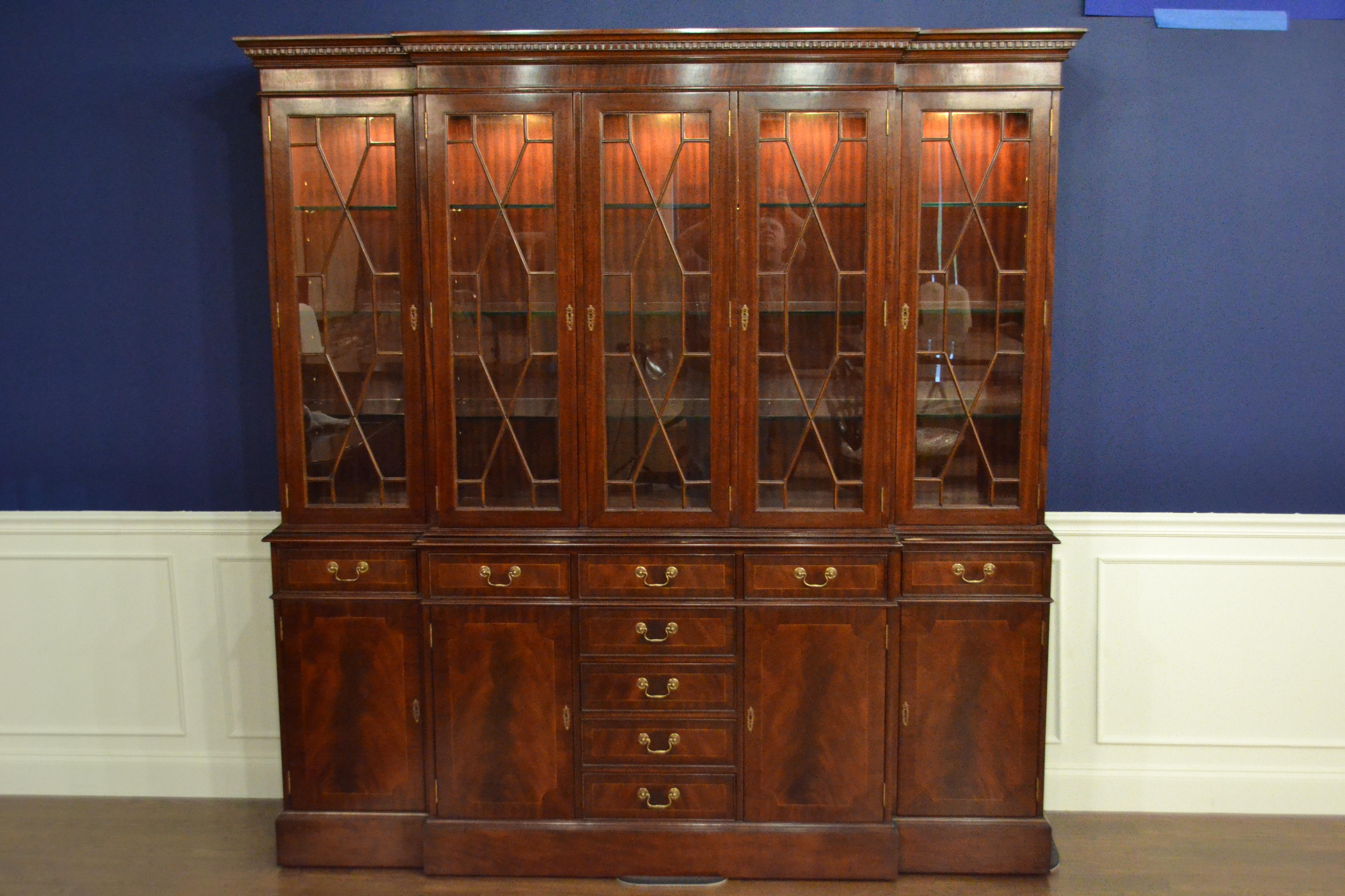 This is the ultimate large traditional mahogany breakfront bookcase or china cabinet with five doors by Leighton Hall. It features four bottom doors and nine drawers with swirly crotch mahogany fields and straight grain mahogany borders. The top