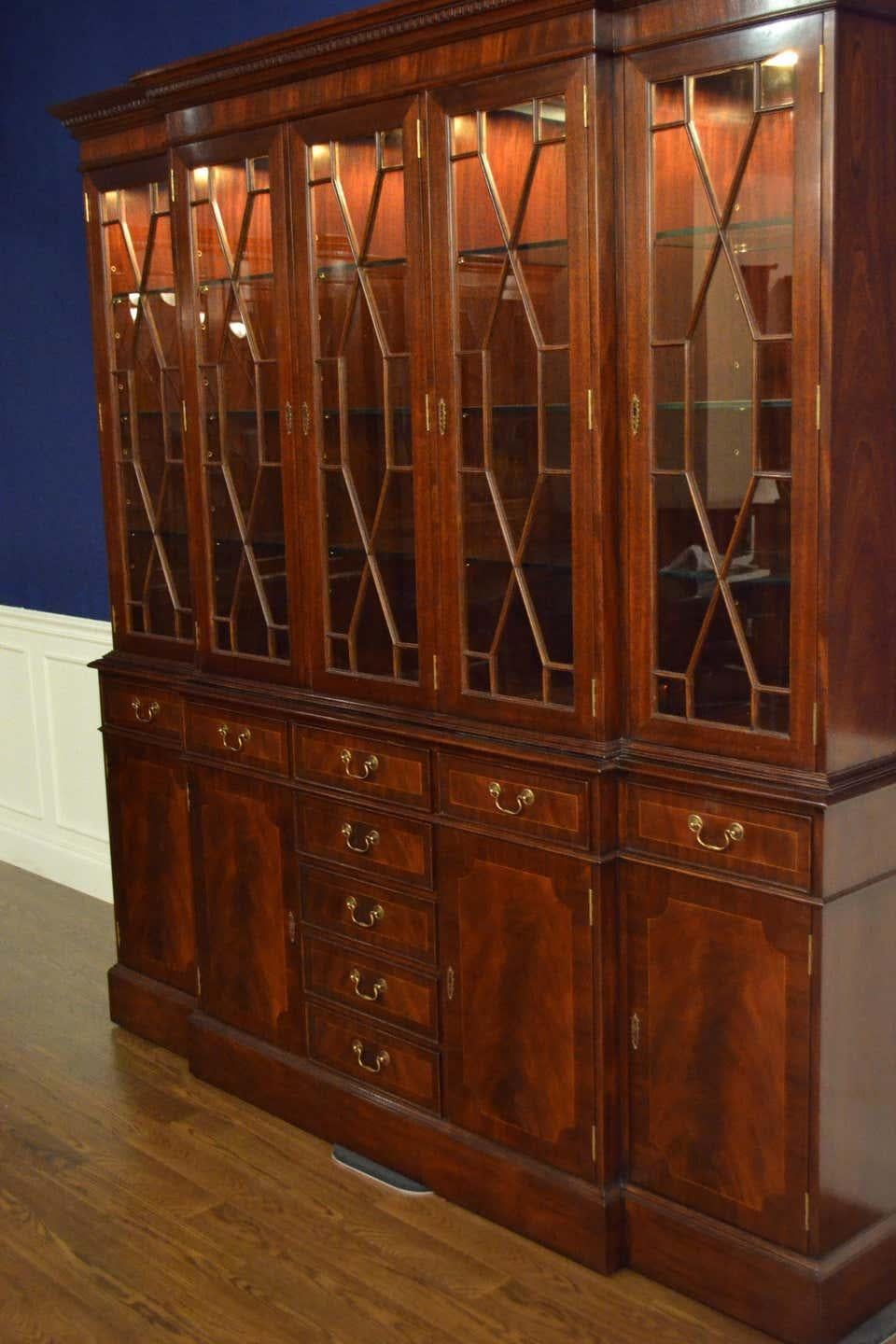 This is a large traditional mahogany breakfront bookcase or china cabinet with five doors by Leighton Hall. It features four bottom doors and nine drawers with swirly crotch mahogany fields and straight grain mahogany borders. The top doors feature