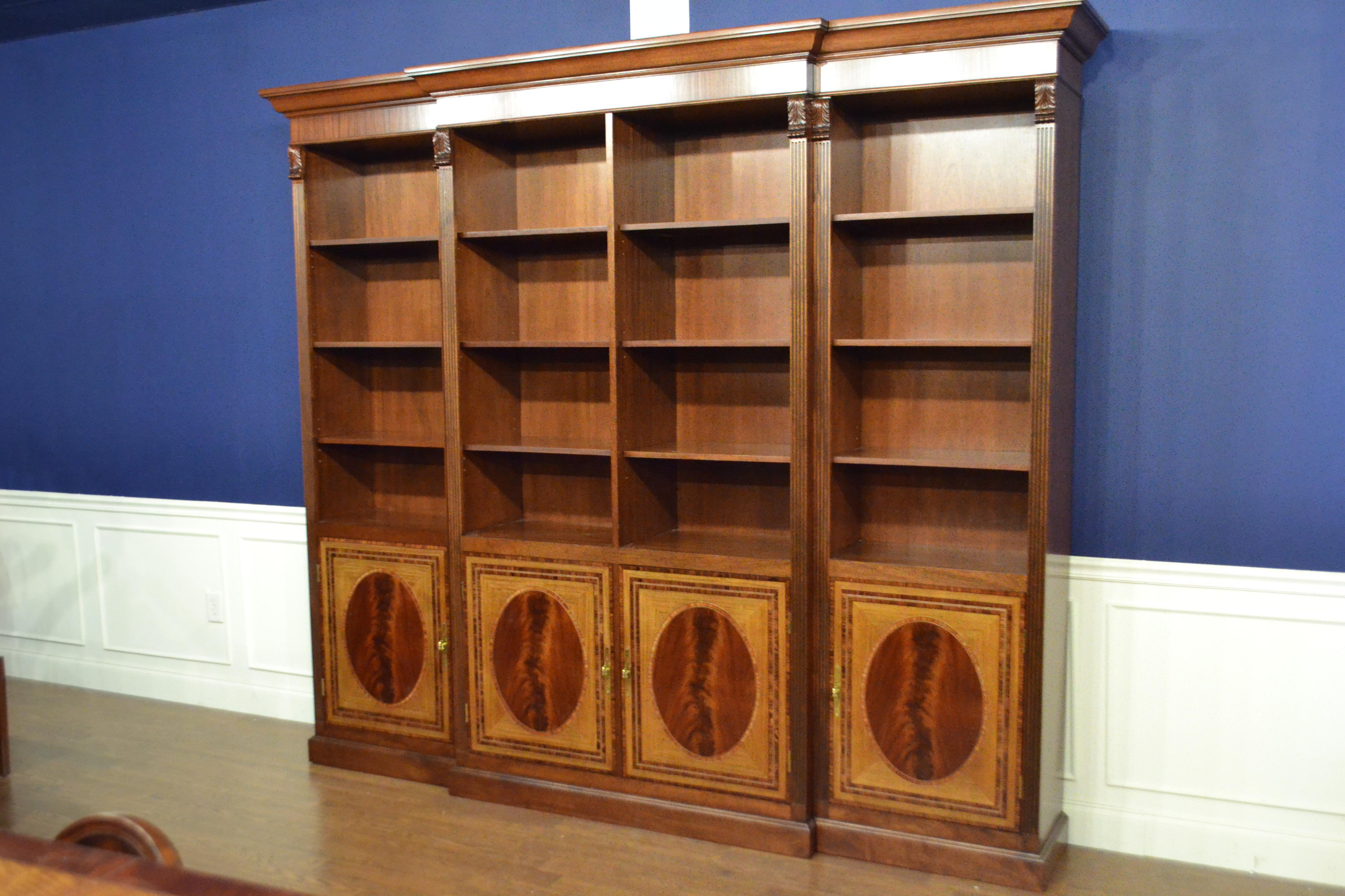 This is made-to-order traditional mahogany bookcase with four doors made in the Leighton Hall shop. It features four doors with swirly crotch mahogany fields and satinwood and santos rosewood borders. The corner posts are fluted with carvings at the