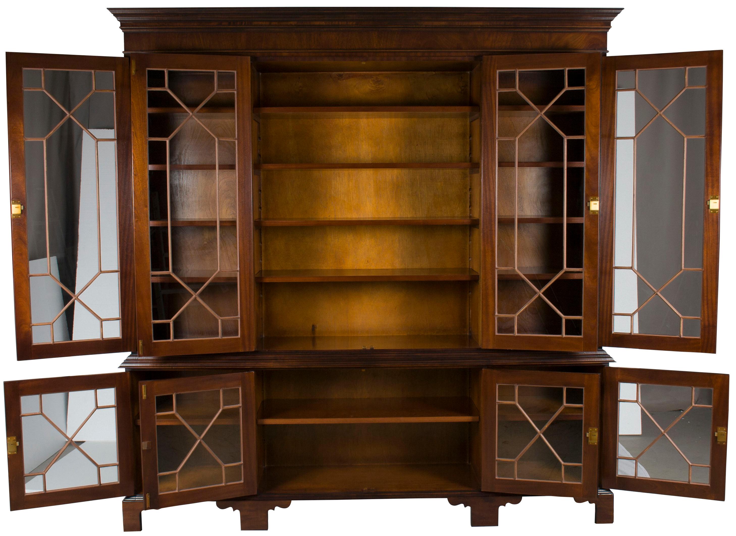 This large antique style bookcase is a newly handmade reproduction originating from the shop of a third-generation cabinetmaker in England. From the materials used to the production values themselves, everything about this bookcase is of the utmost