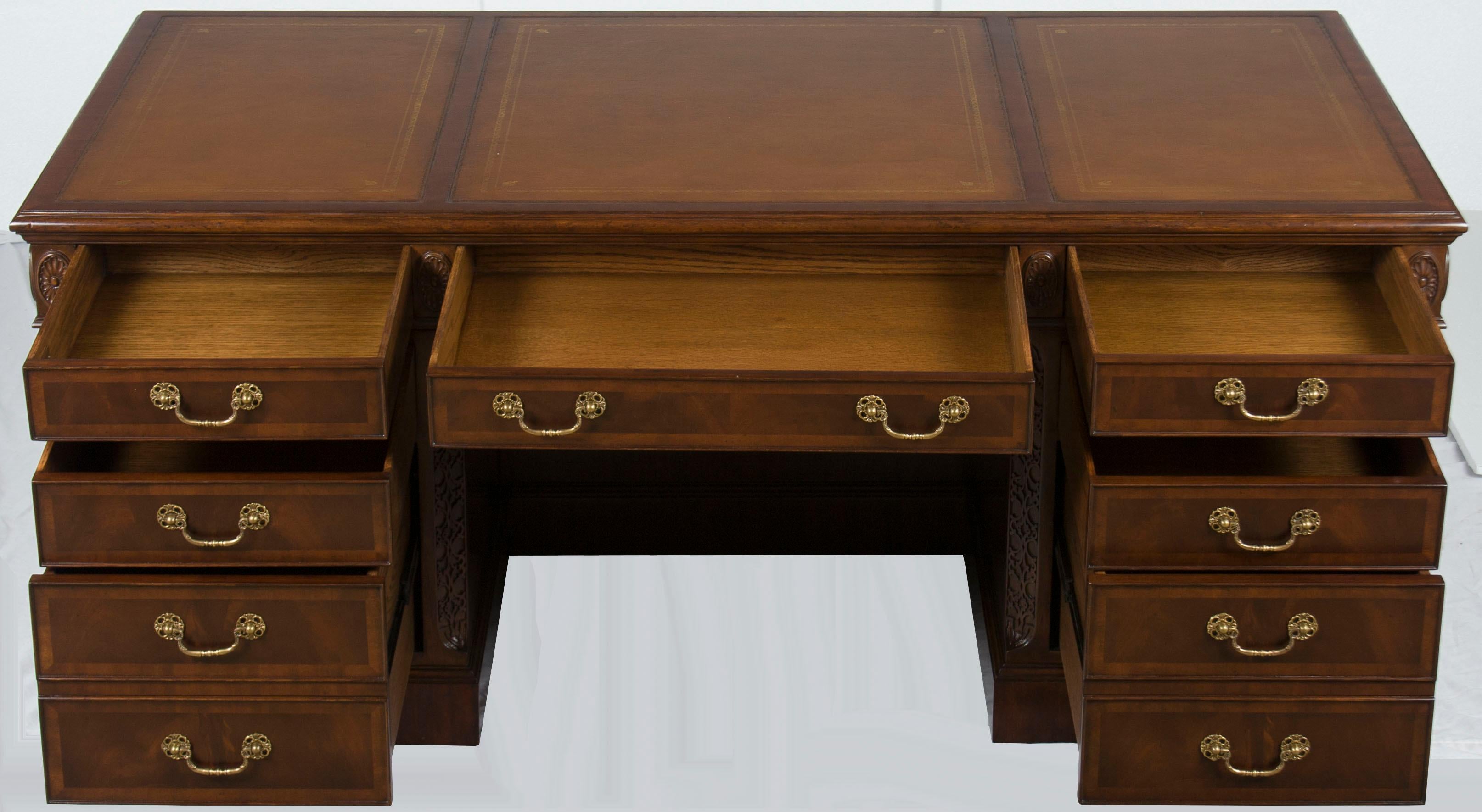 This stunning large home office desk provides a great work space and luxurious drawer storage! It features subtle carved decorations, stunning flame mahogany, and supple leather to create a classical and distinguished look. With both style and