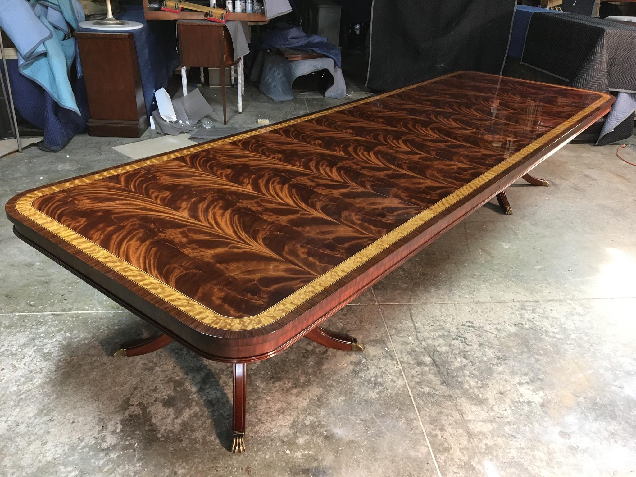 This is a made-to-order Large Traditional mahogany banquet/dining table made in the Leighton Hall shop. It features a field of slip-matched swirly crotch mahogany from west Africa and satinwood and santos rosewood borders from South America. It has