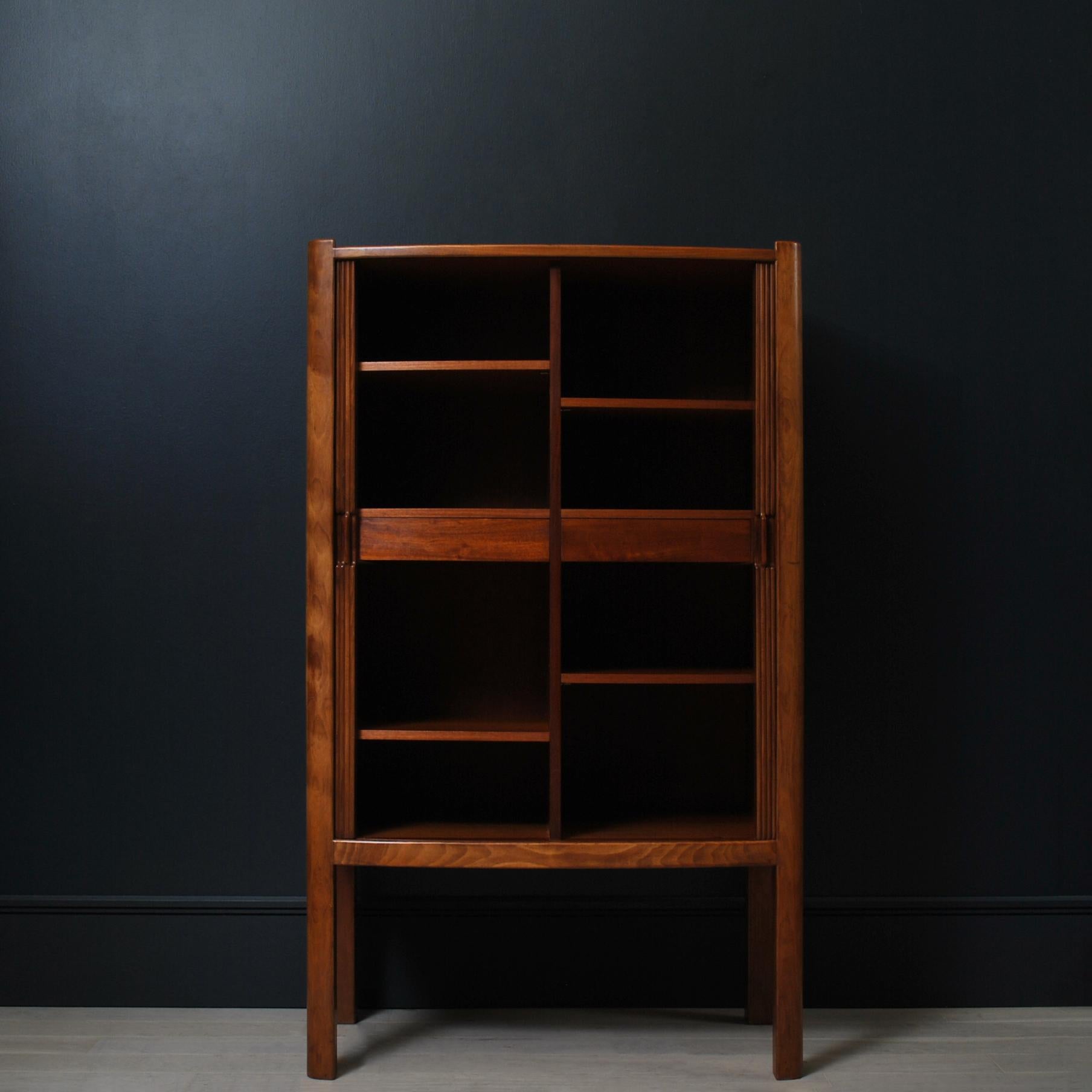 An outstanding large and tall tambour cupboard/cabinet in Cuban Mahogany with interior of teak. This piece of fine furniture is of significant design heritage and importance - coming from a design and maker pairing in the early careers of Kristian