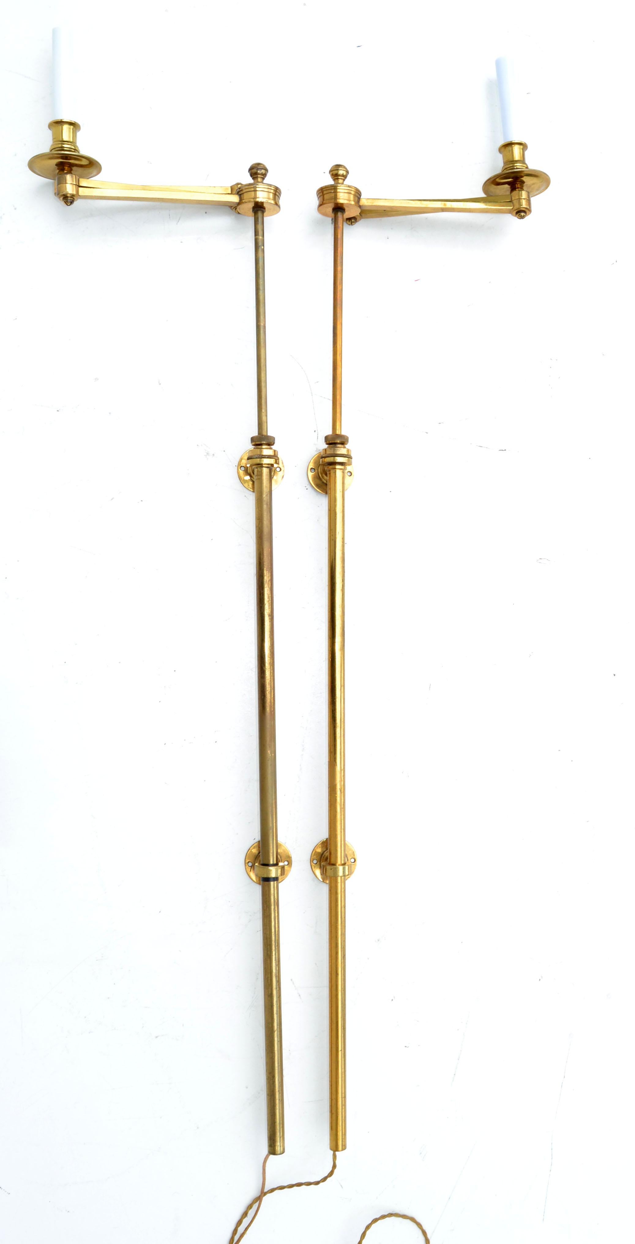 Pair of Mid-Century Modern retractable sconces, wall lamps, wall lights by Maison Bagues, made in France. One of the last Parisian Bronzier 
Back plate measures: 2.75 inches. Costume Junction Box Covers are available for purchase. 
Comes with