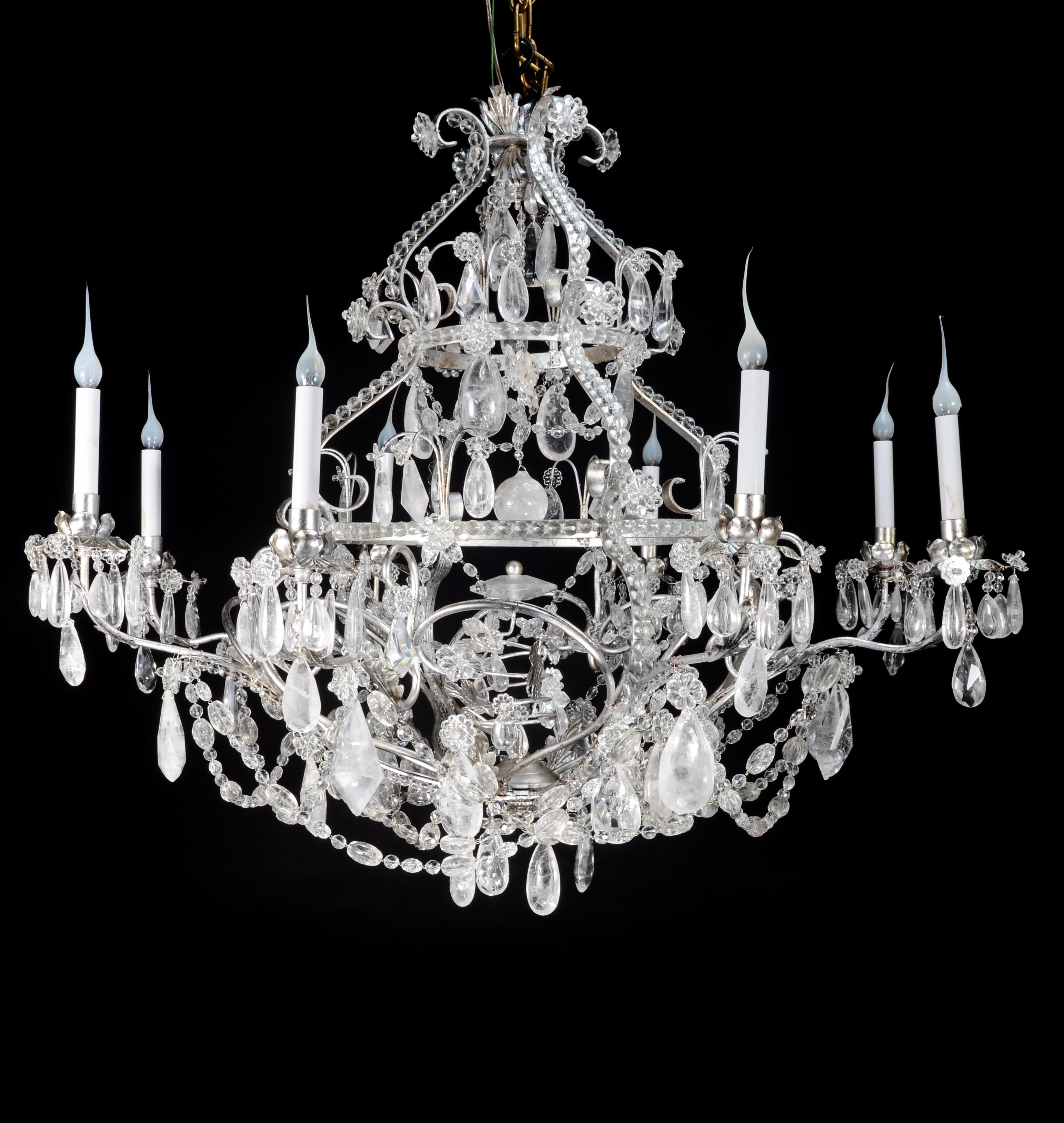A magnificent and finely crafted French 20th century silver gilt and rock crystal chandelier, executed in the style of Maison Baguès. This striking multi-tiered fixture is centered by a faceted baluster stem above a delicate inverted finial sphere,