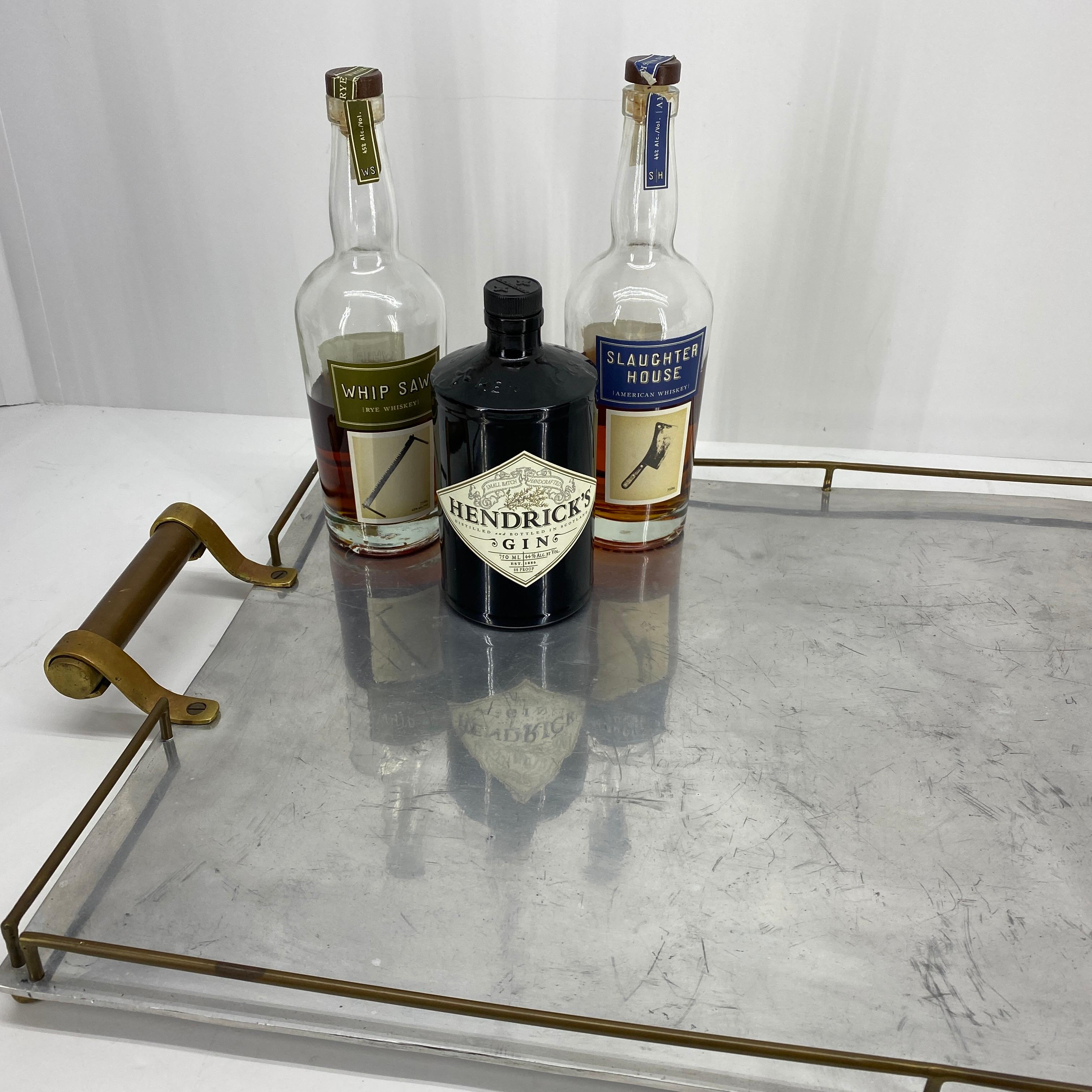 Large rectangular serving tray in chrome and with two side handles in brass. The tray is in great vintage condition. Minor wear consistent with age, one brass bar is bent. Please see detailed images attached.