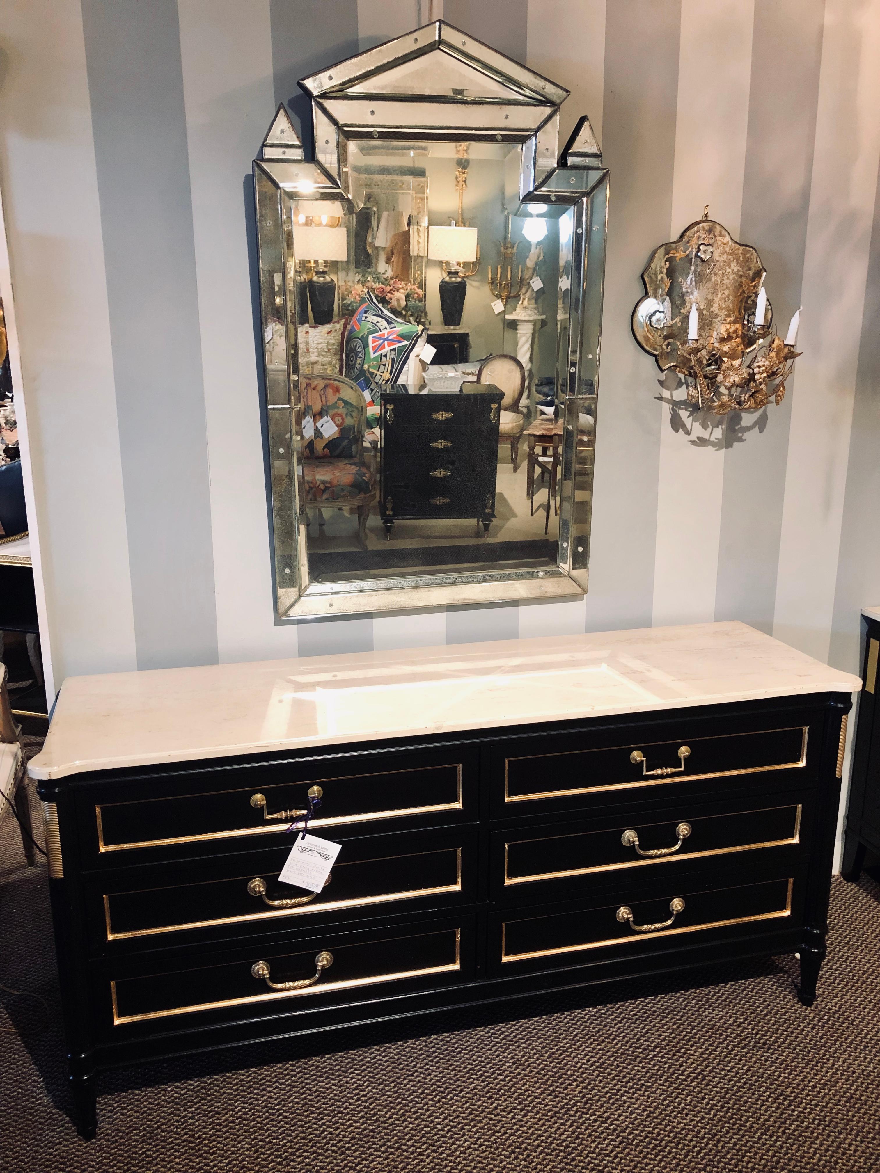 Maison Jansen style ebony marble-top dresser commode chest of drawers. In the Louis XVI style with ebony and bronze adorned decoration this stunning palatial server or dresser is multi functional and can be used in many settings. Having the Maison