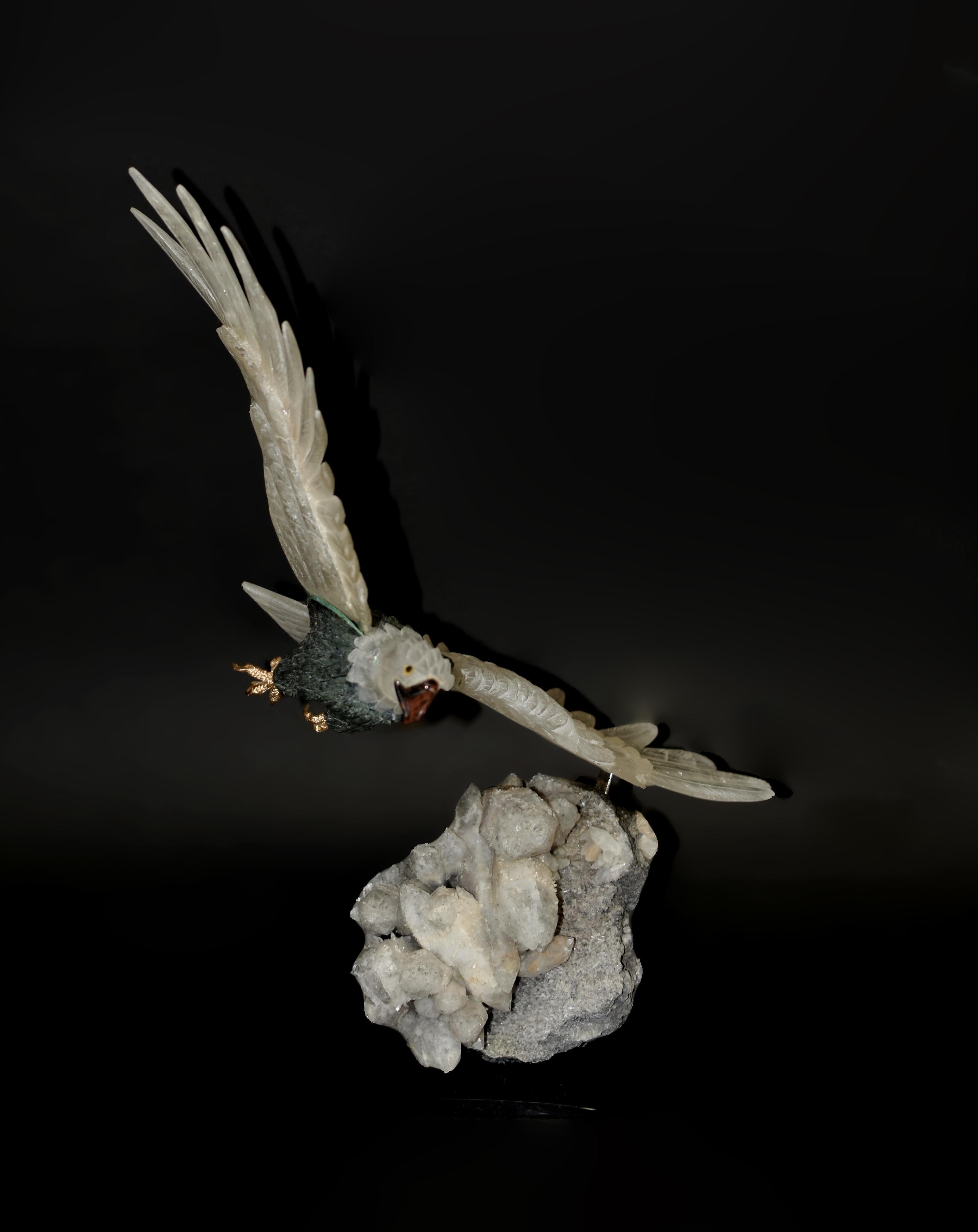 Crafted with the greatest artistry and exquisite precision, the one of a kind, majestic rock crystal quartz eagle commands attention with its awe-inspiring presence. With a wingspan stretching an impressive 19 inches, each feather meticulously