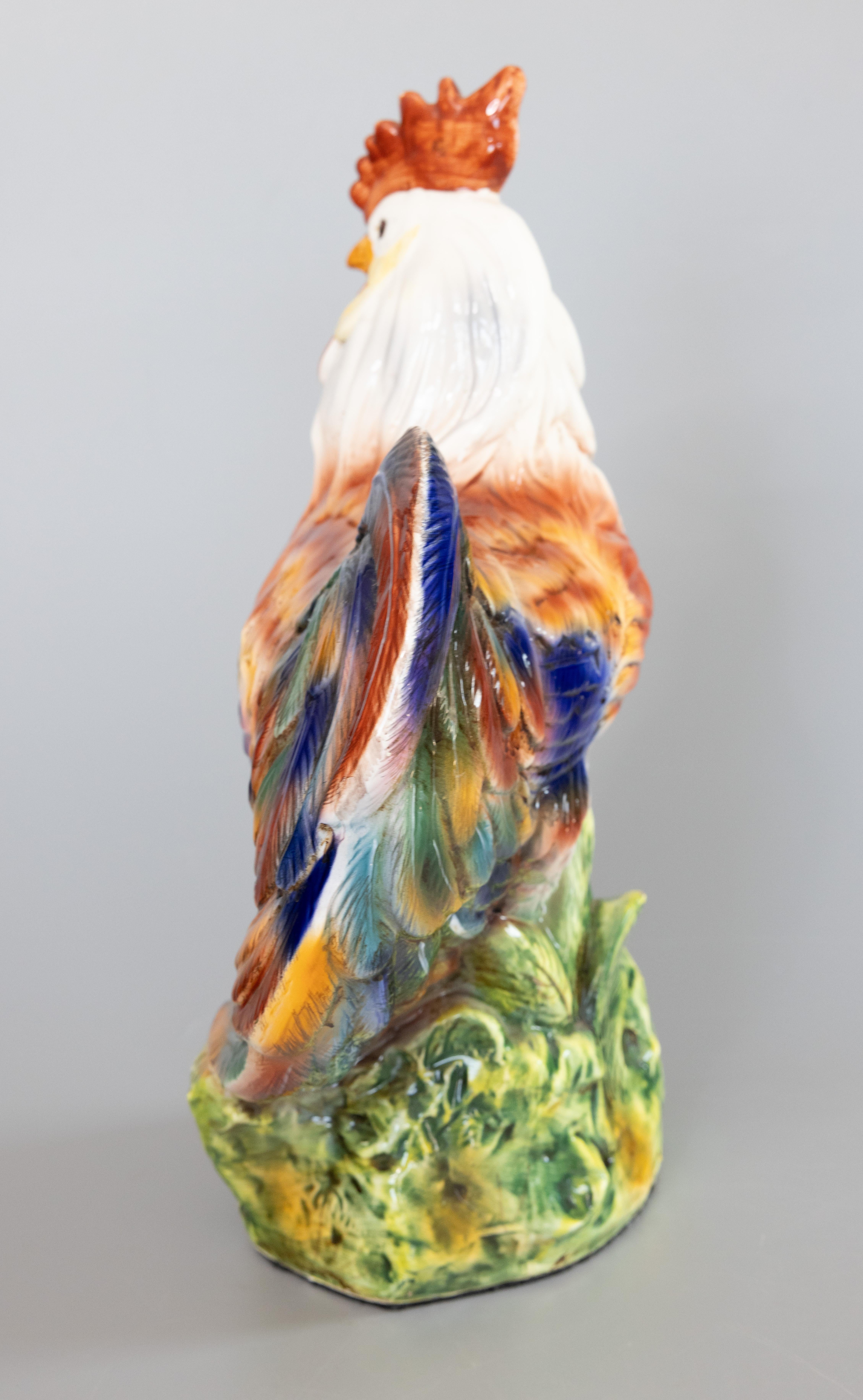 A marvelous, large majolica rooster, handsome and proud, painted in vibrant reds, blues, greens, and yellows. Marked on collar.