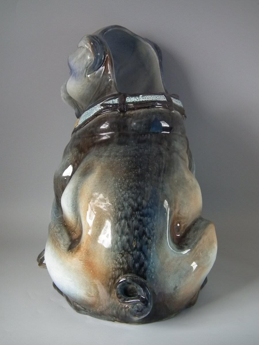 Unidentified European Majolica stick or umbrella stand which features a Pug. Colouration: grey, blue, brown, are predominant.
