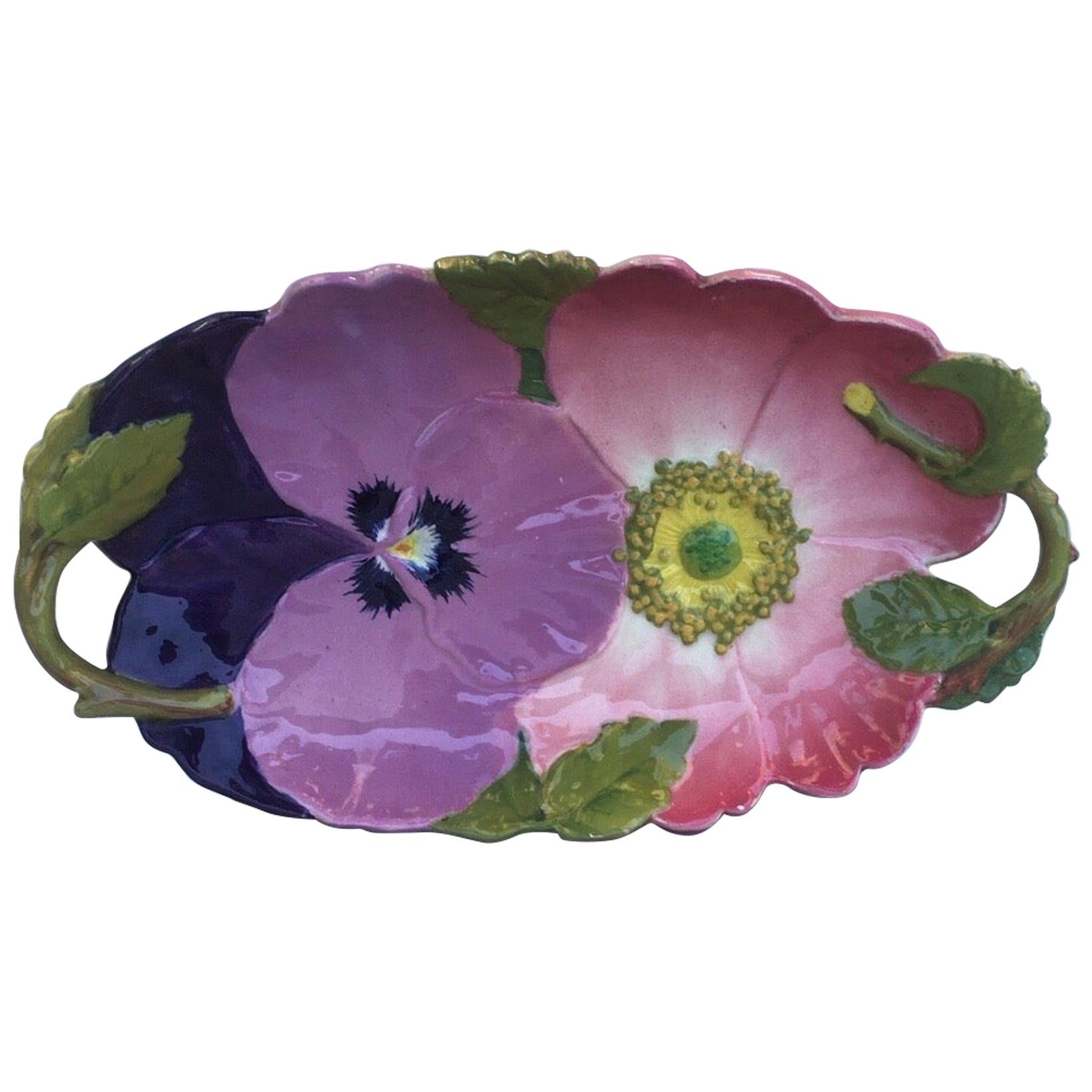 Charming Art Nouveau Majolica handled platter with a wild rose and a pansy attributed to Massier Circa 1890.
Measure: 17 inches length.