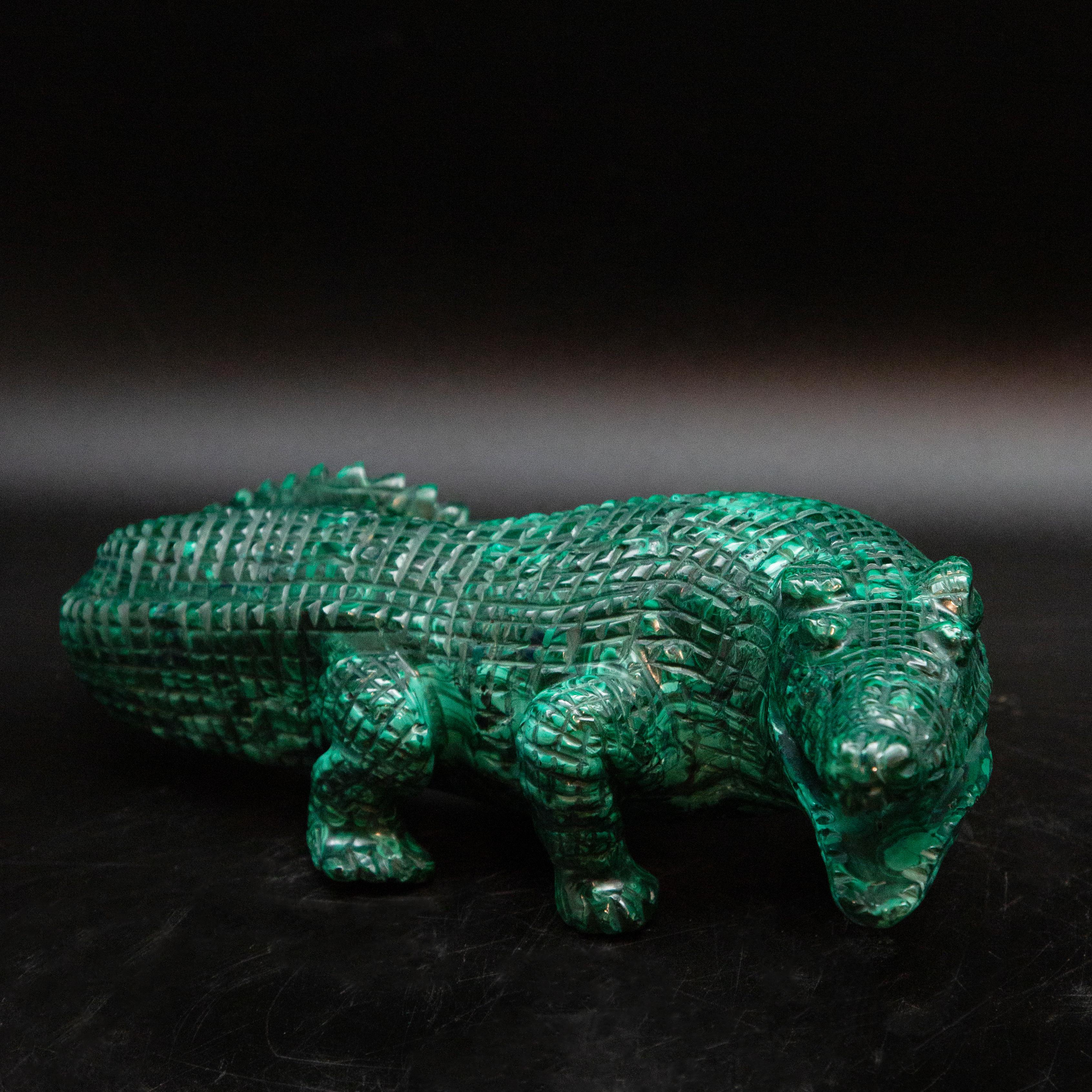 Large hand-carved Malachite Alligator. The malachite for this carving was sourced from and carved in the Congo, where the finest quality of this mineral is currently found. Carvings such as this were typically brought back from Europe as 