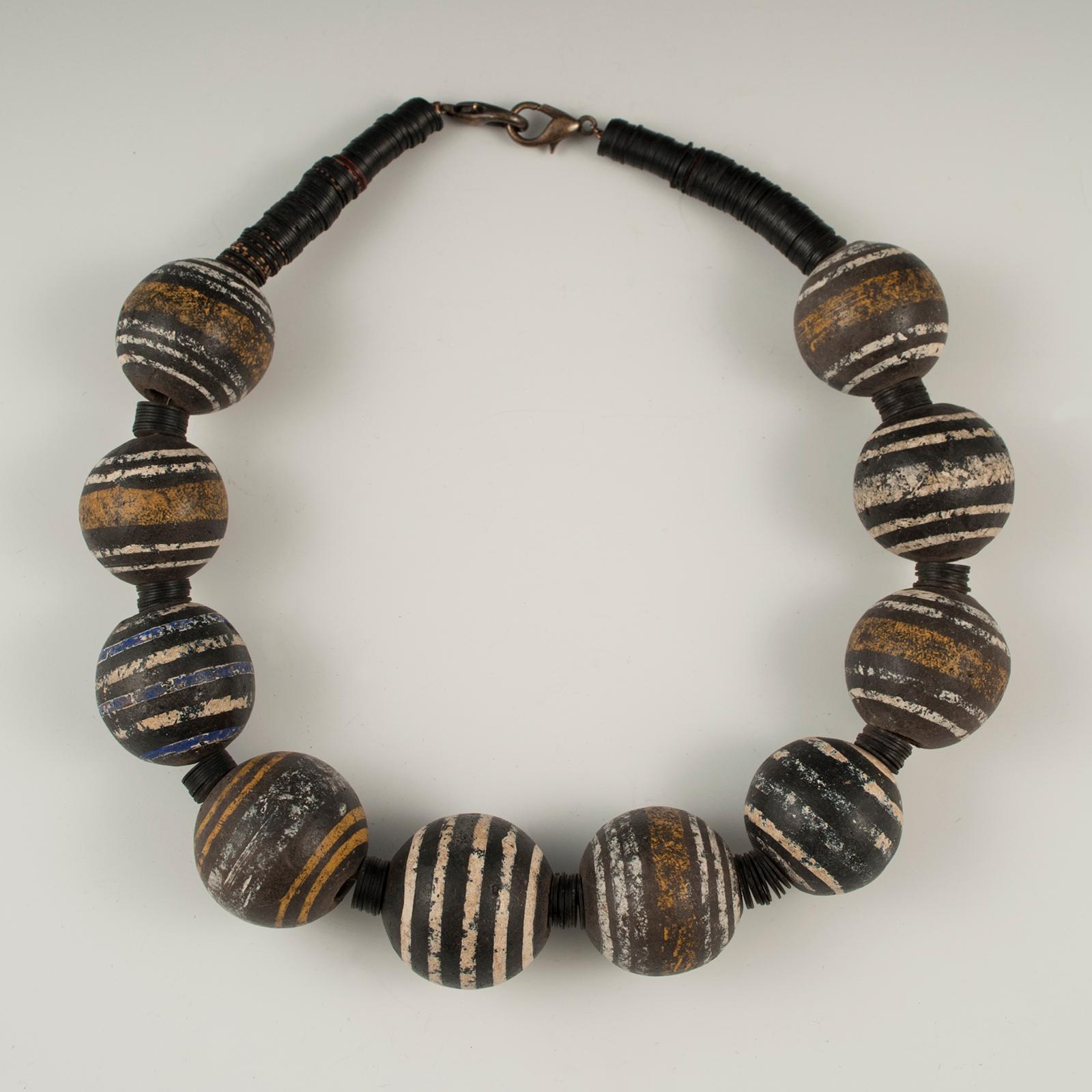 Offered by Zena Kruzick
Large Mali terracotta tribal bead necklace by Claire Ginioux, Paris, France.

Mali terracotta beads from the 19th century and small black disks are combined in a strikingly graphic bead necklace.
The inner circumference