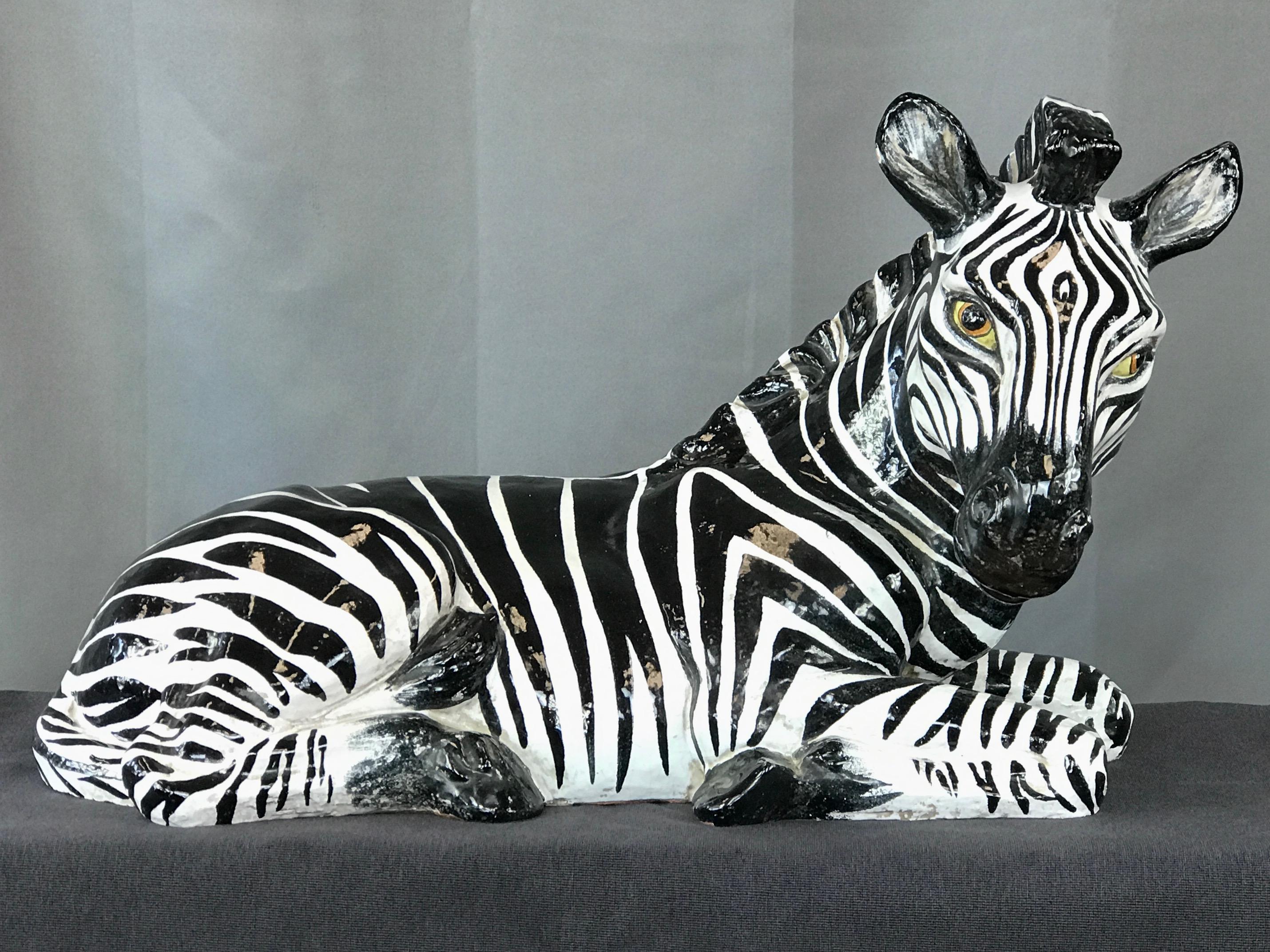 A large Hollywood Regency Italian glazed terracotta zebra sculpture in the style of Manlio Trucco.

Rendered nearly life-size to that of a newborn foal in repose. Crisply hand painted in visually striking glossy black and white glaze with shaded