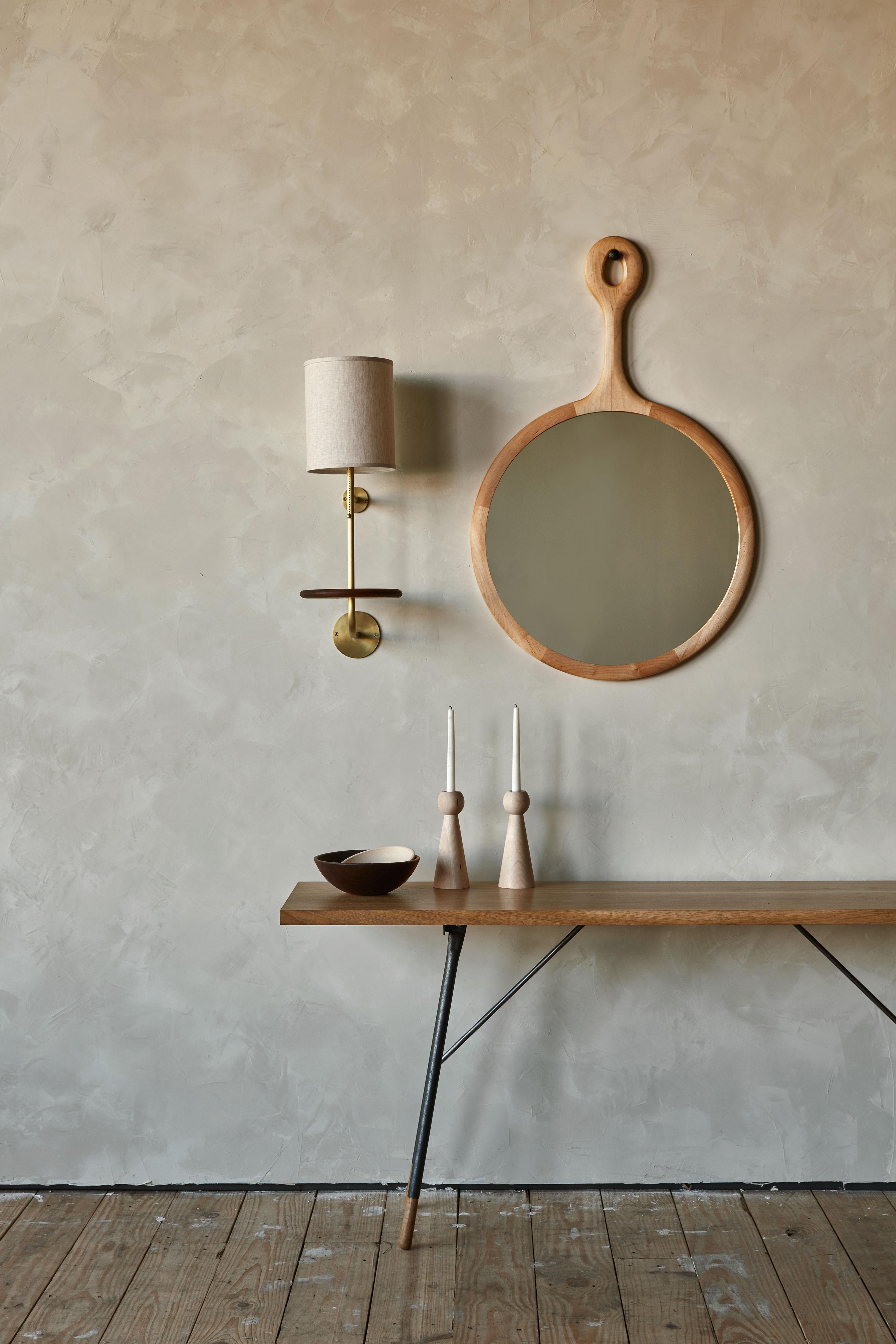 The Sophia mirror is framed in wooden maple with a long neck resembling an oversized hand mirror. Handcrafted in Pennsylvania, the Sophia comes with a hand-hammered iron peg for hanging. The medium is a lovely size above a dresser or in a hallway.