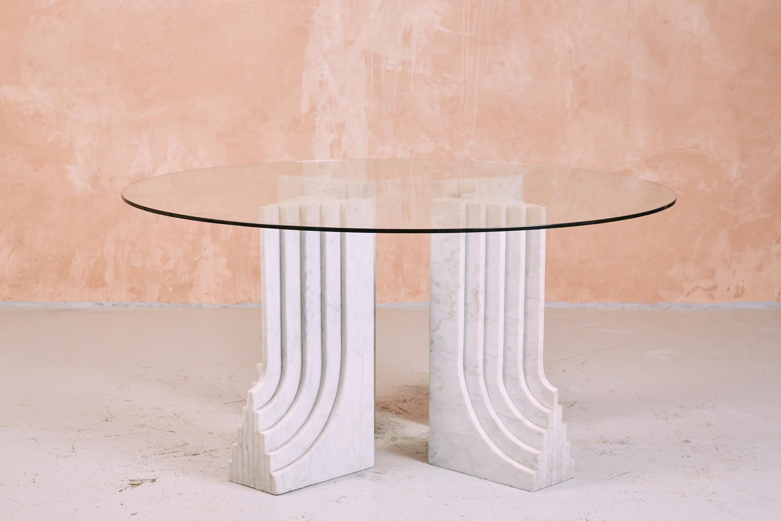 Four sculptural marble plinths combine to provide the base for this very large table.

While this table is not the Samo by the Scarpas, it is most certainly based upon it. The “Samo” dining table was designed in 1971 for 'Ultrarazionale'