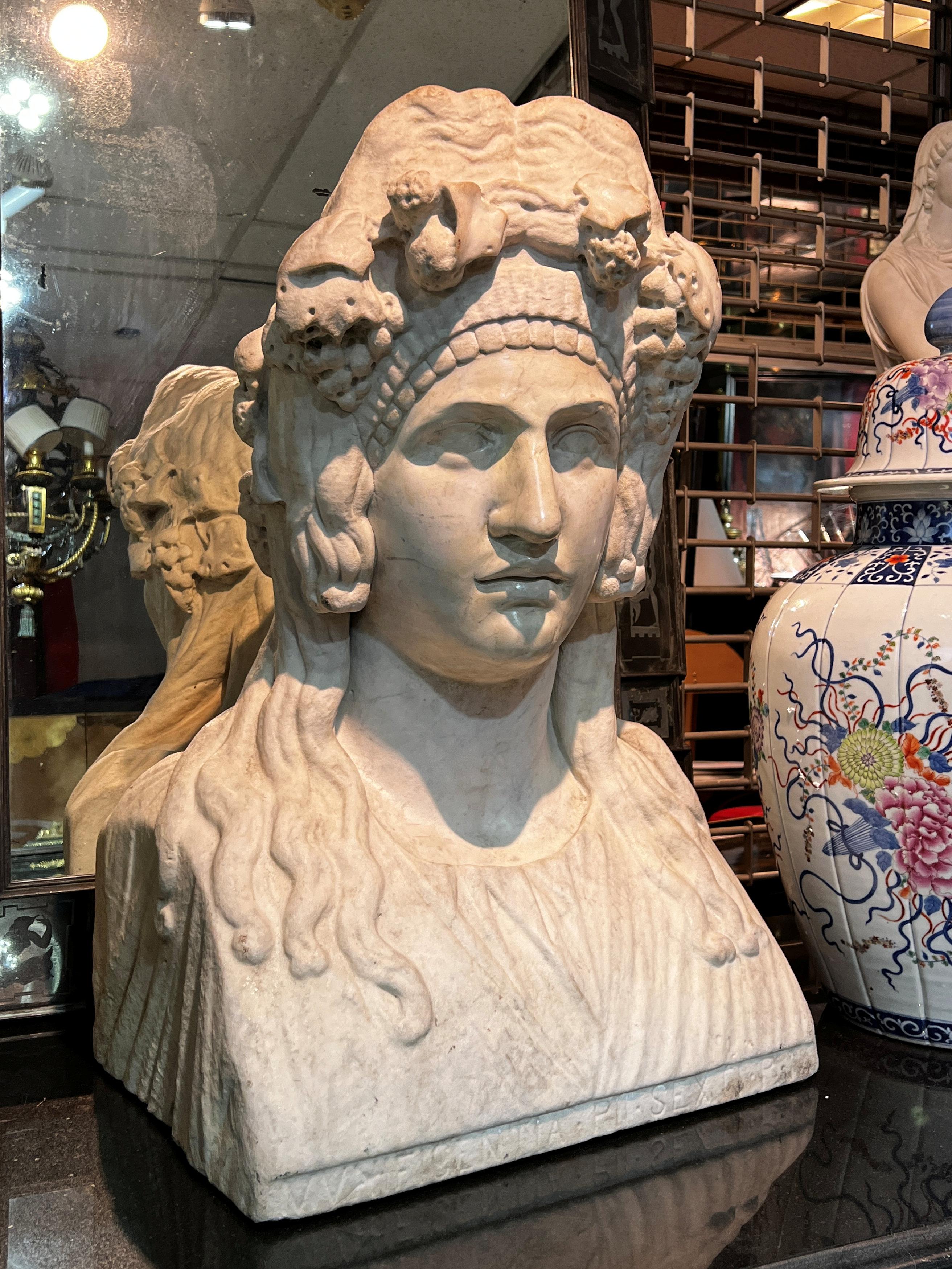 Our pair of very large antique marble busts depicting Tragedy and Comedy, after the original second century herms uncovered outside the entrance to the theater of Hadrian's Villa in the 18th century, each measure 18 inches wide, 13 inches deep, and