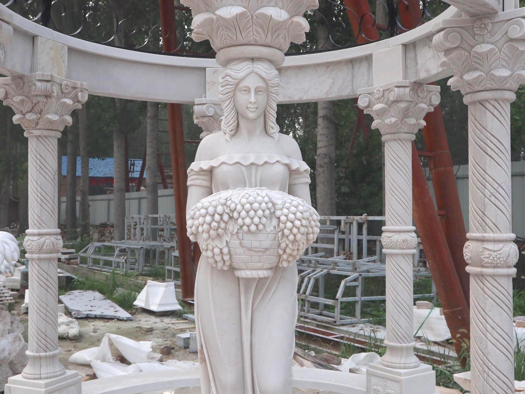 Beautiful circular gazebo with carved women and iron dome.
 