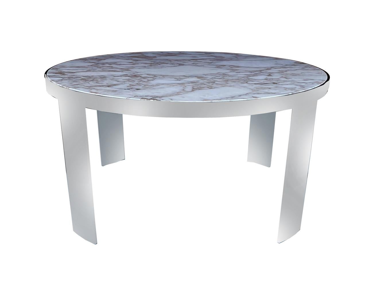 A large and impressive circular dining table designed by Leon Rosen and produced by Pace in the 1970's. It consists of a chrome plated steel base with inlayed Italian calacatta gold marble.