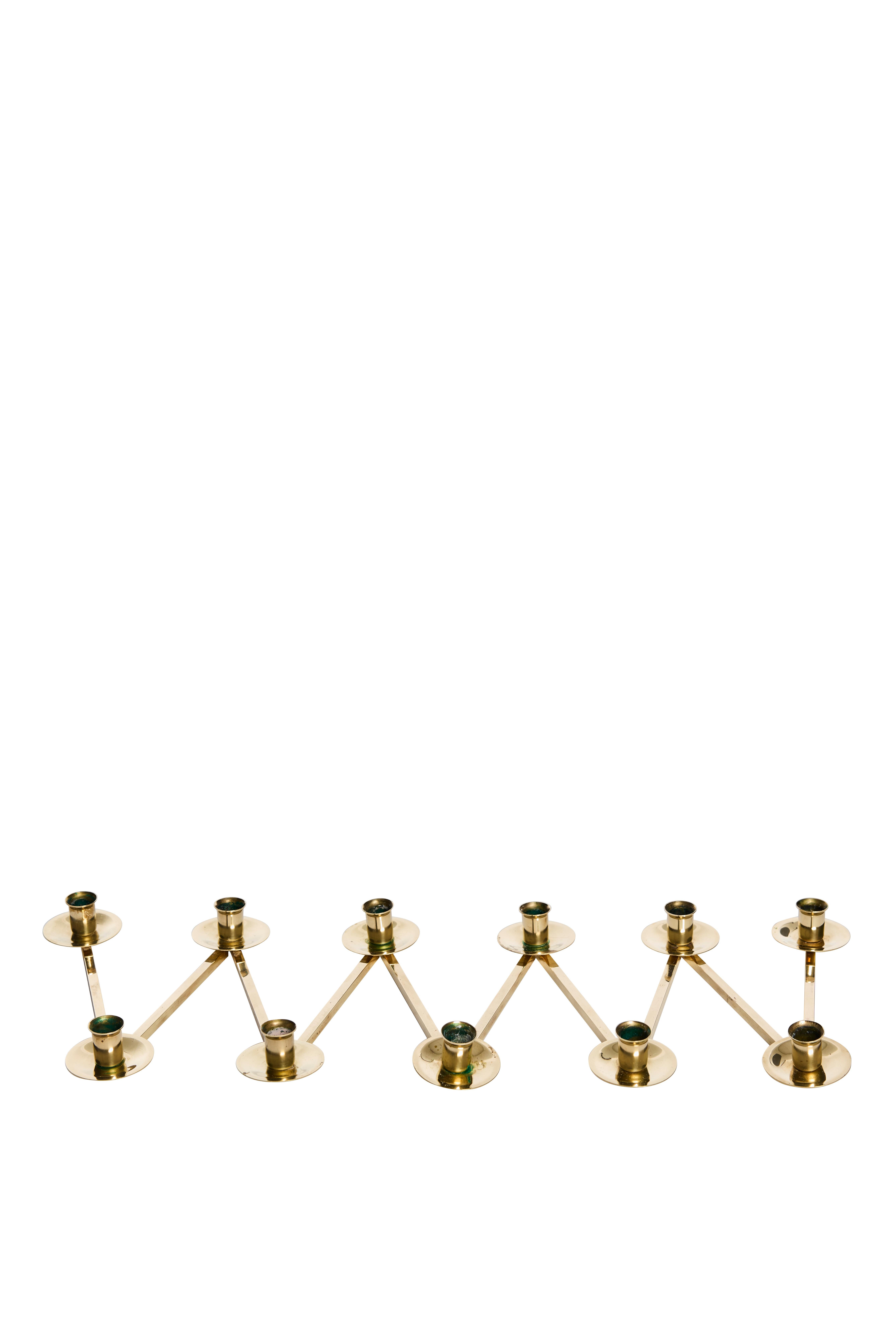 Elegant, inventive, and enduringly modern, this rare modular brass candleholder set was designed by renowned Swedish metalsmith Lars Holmström and produced in Sweden during the 1920s. The design is part of Holmström’s celebrated Margareta series and