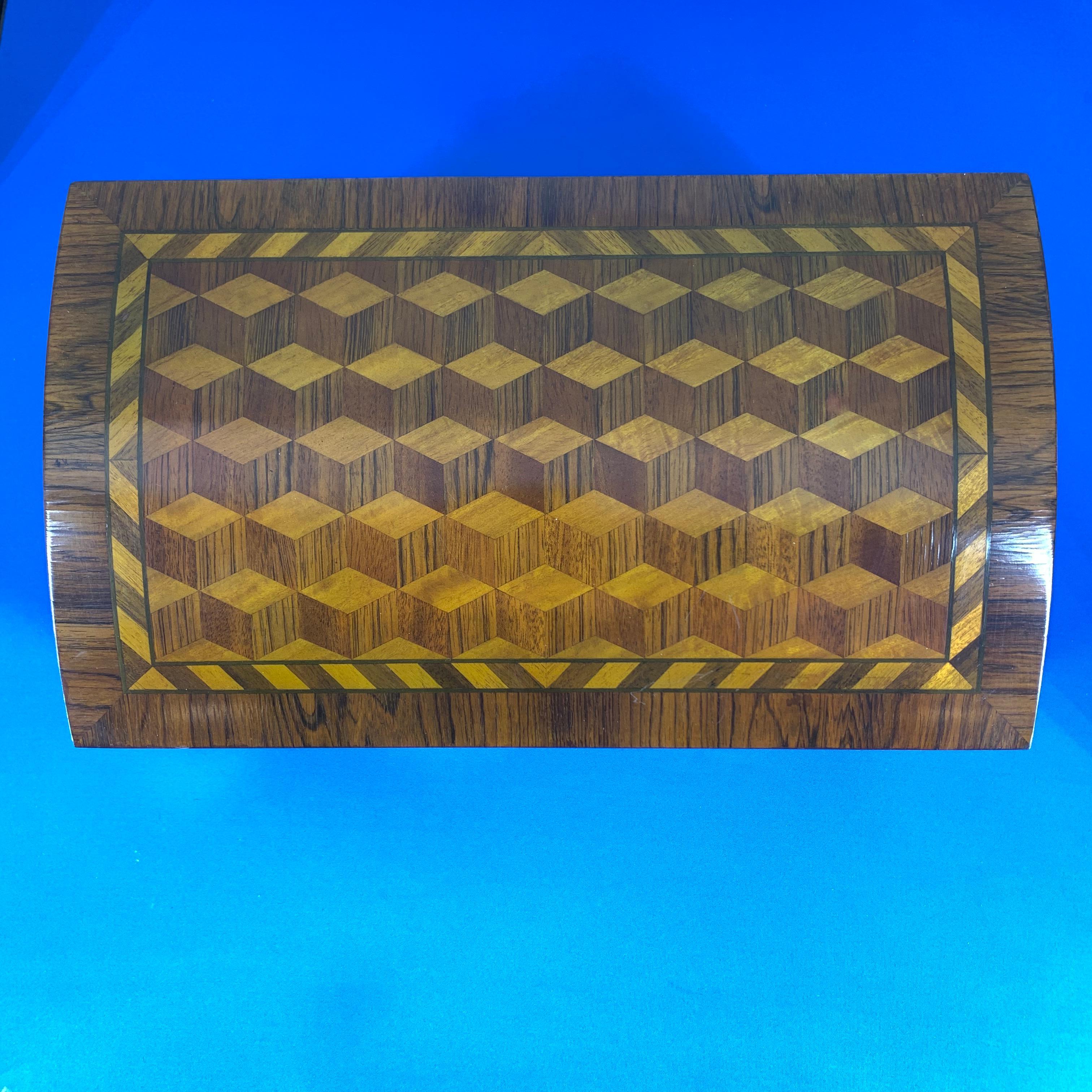 Large decorative marquetry jewelry box with dome lid and gilded feet.
 