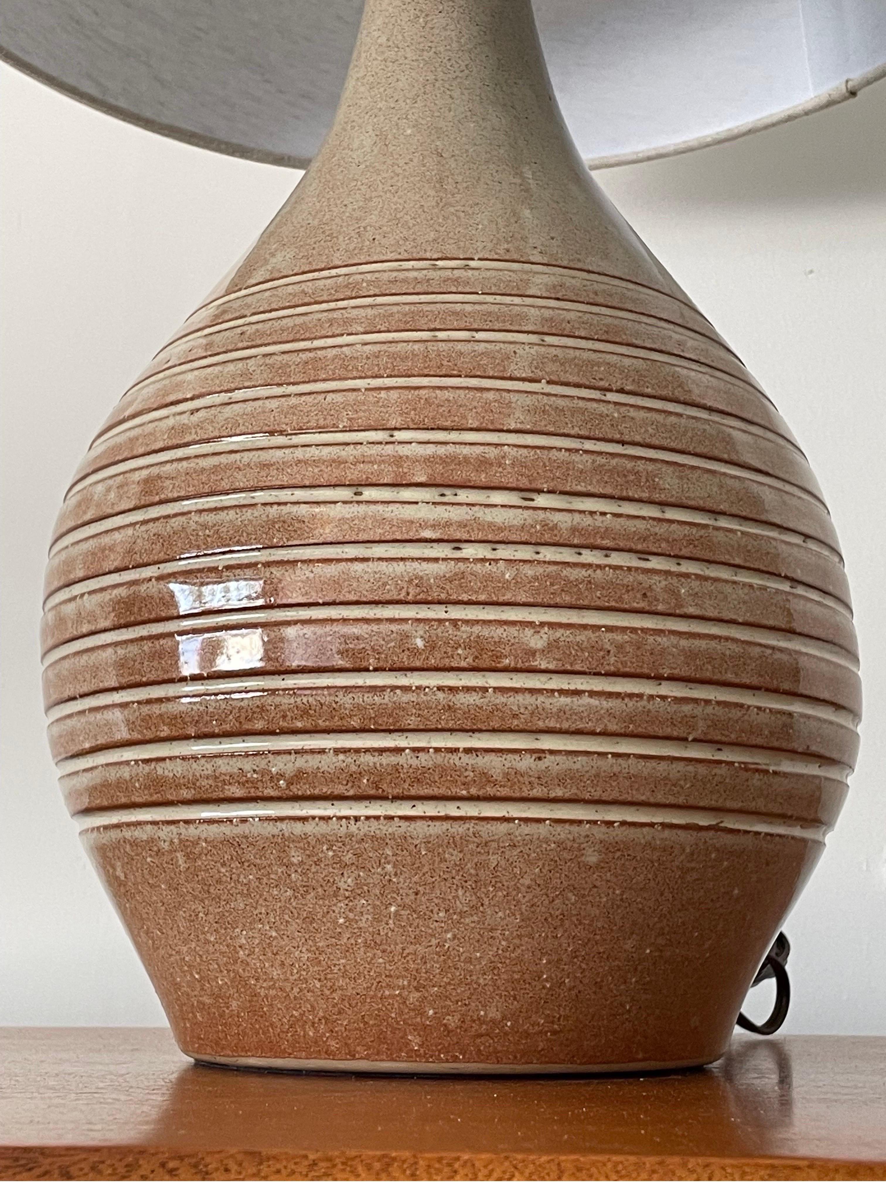 Large tear drop shaped table lamp designed by famed ceramicist duo Jane and Gordon Martz for Marshall Studios. Features a rose/ blush glaze with tan underbody. Striped incised detailing. 

Overall:
25” tall
15 wide

Ceramic only:
14” tall
9”