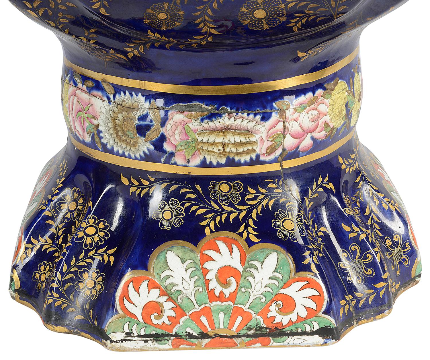 A very impressive large 19th century Masons iron stone pagoda style lidded vase. Having the classic Imari colours if cobalt blue ground and orange highlights. Inset painted panels depicting oriental scenes, mythical cat like gilded handles to either