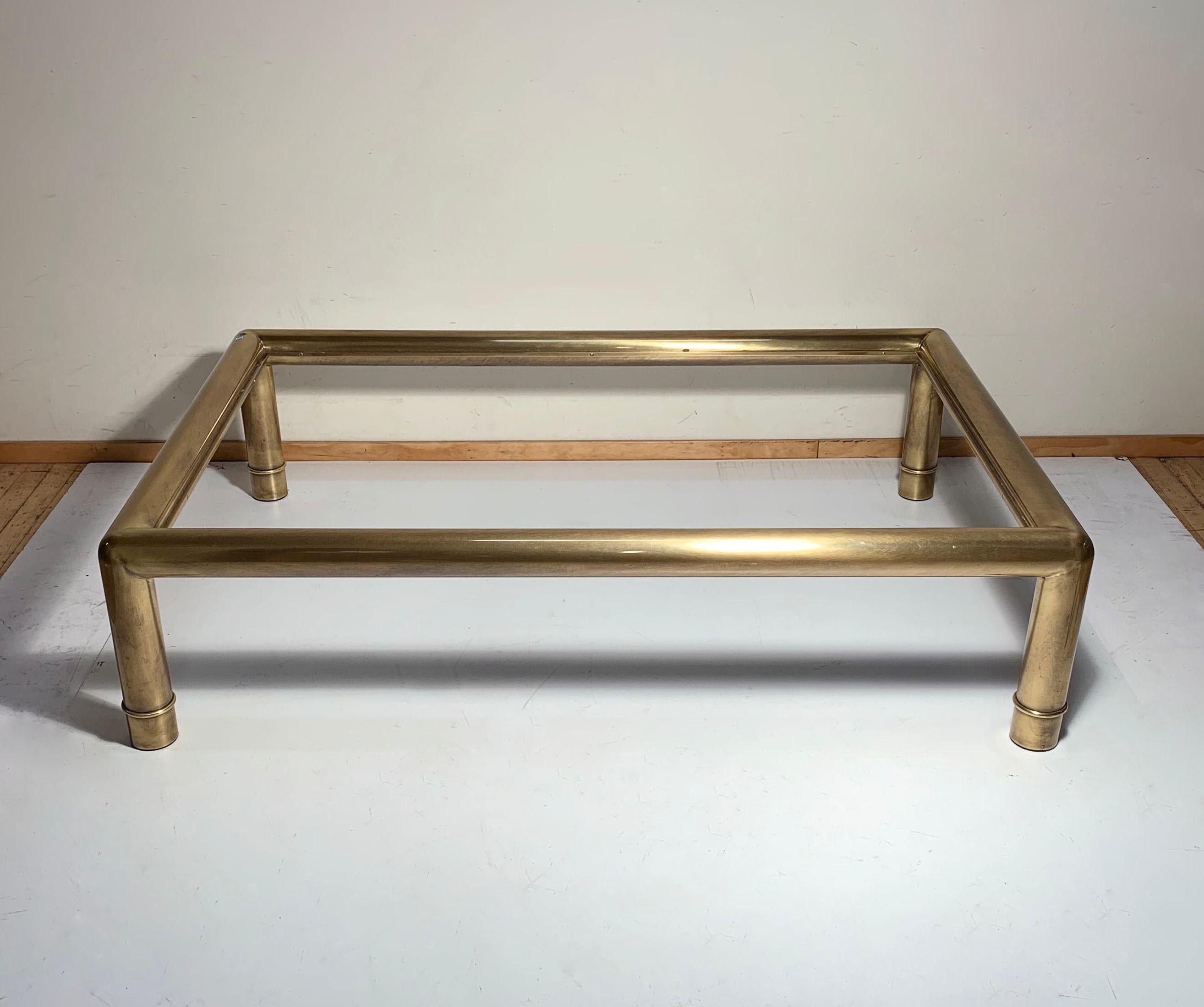 A large oversized rectangular Mastercraft brass coffee table.

Table comes with the original glass with bevelled edge.