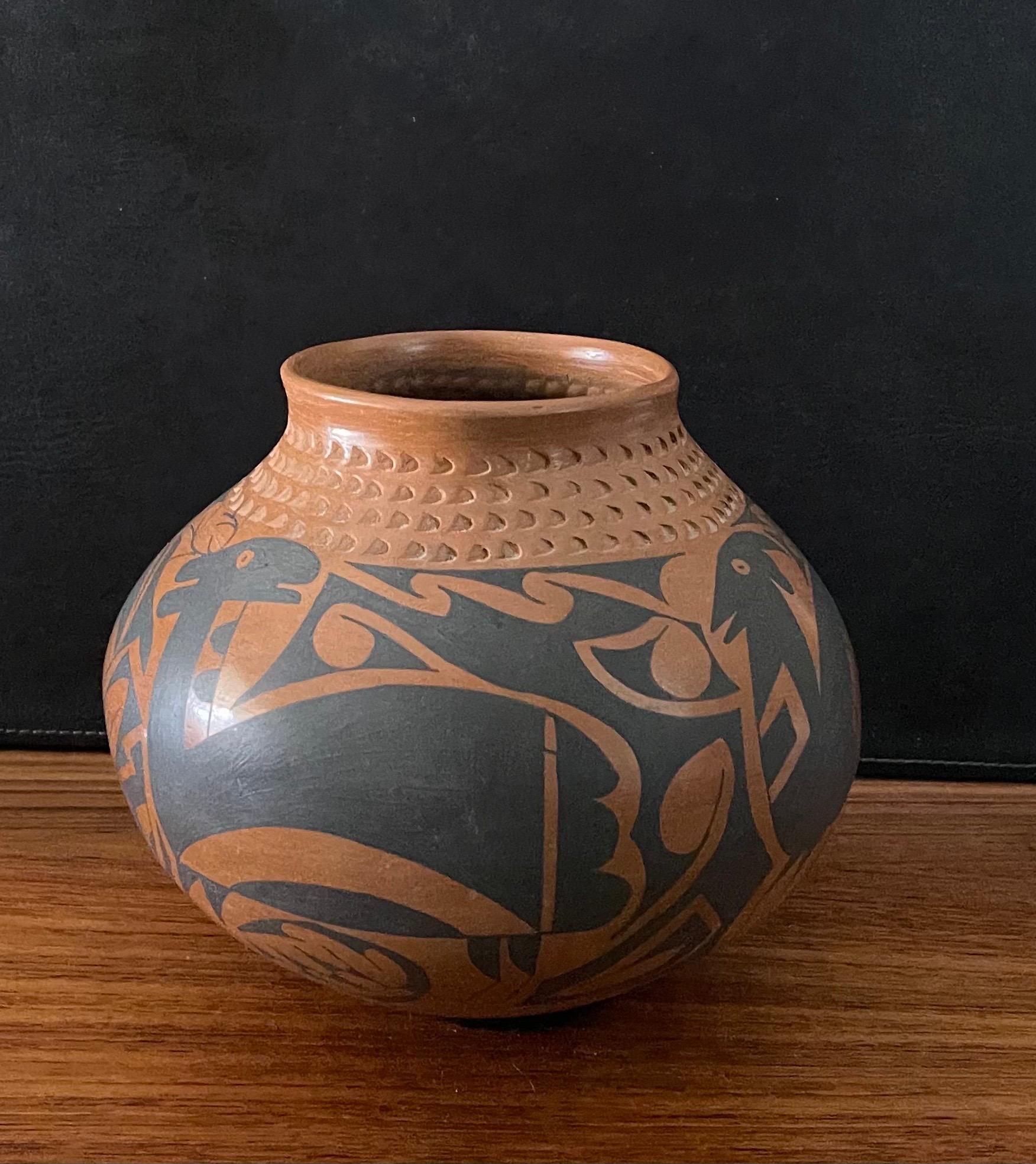 Beautiful hand-turned large Mata Ortiz polychrome pottery vessel with goat motif by Daniel Gonzales, circa 1990s. The exquisite piece made of naturally brown clay has a unique black goat design. This vase is in very good condition and measures