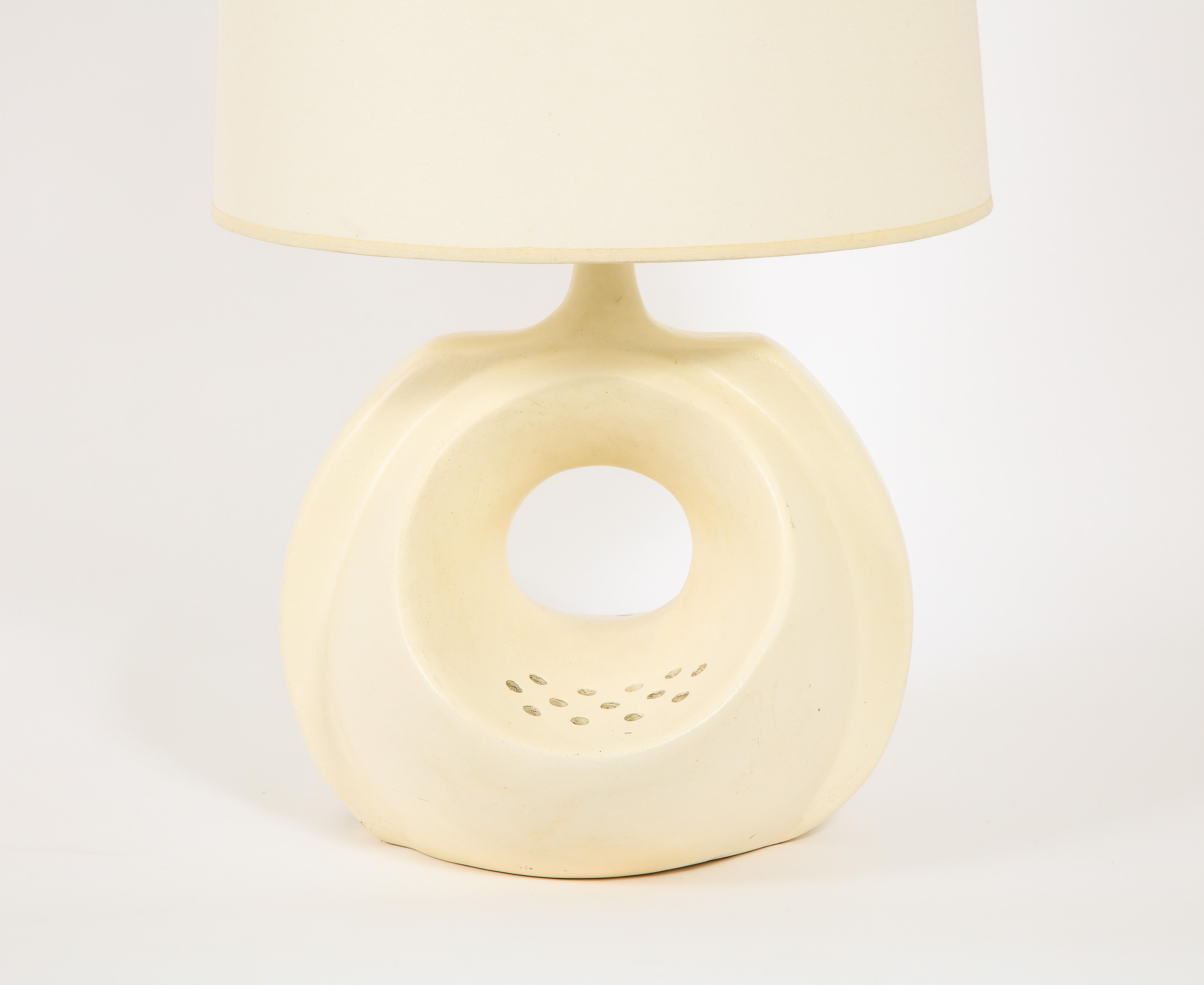 Amazing pottery studio lamp in a matte glaze, one uplight, and an inner light that glows through the cutouts seen in the curved opening below the neck. 

Shade not included.