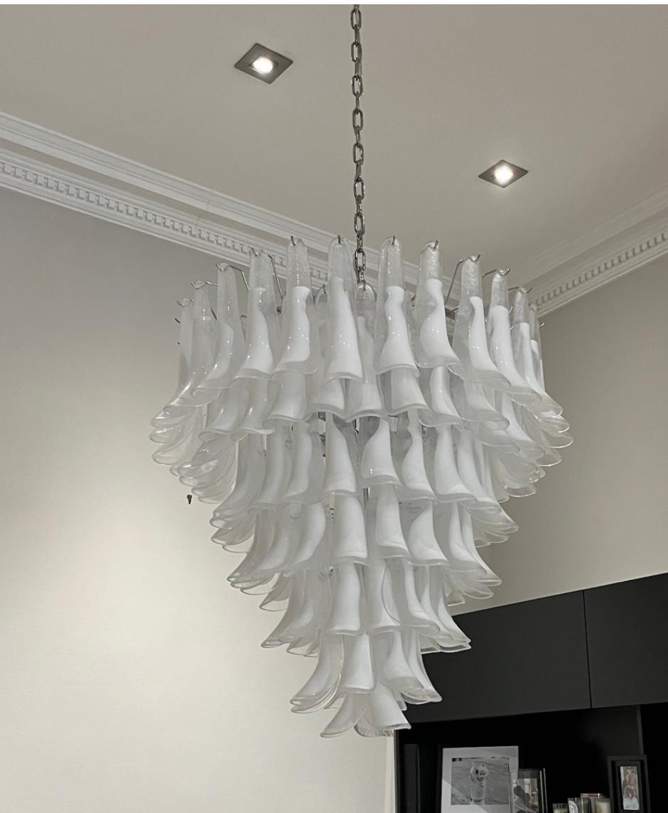 Large and glamorous hand-blown glass Murano chandelier. Comprised of 120 clear and white striped glass petals, hanging from a chromed metal armature wired with 9 sockets. This is a large version of this classic Mazzega tiered cascading form. 7 tiers