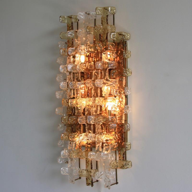 Large wall sconce by Mazzega. Italy, Mazzega, 1970s.

Brass base and construction with 24 pieces of clear and amber glass pieces. Eight light fittings.
Condition: 

Very good vintage condition, two pieces of glass with imperfections.
 