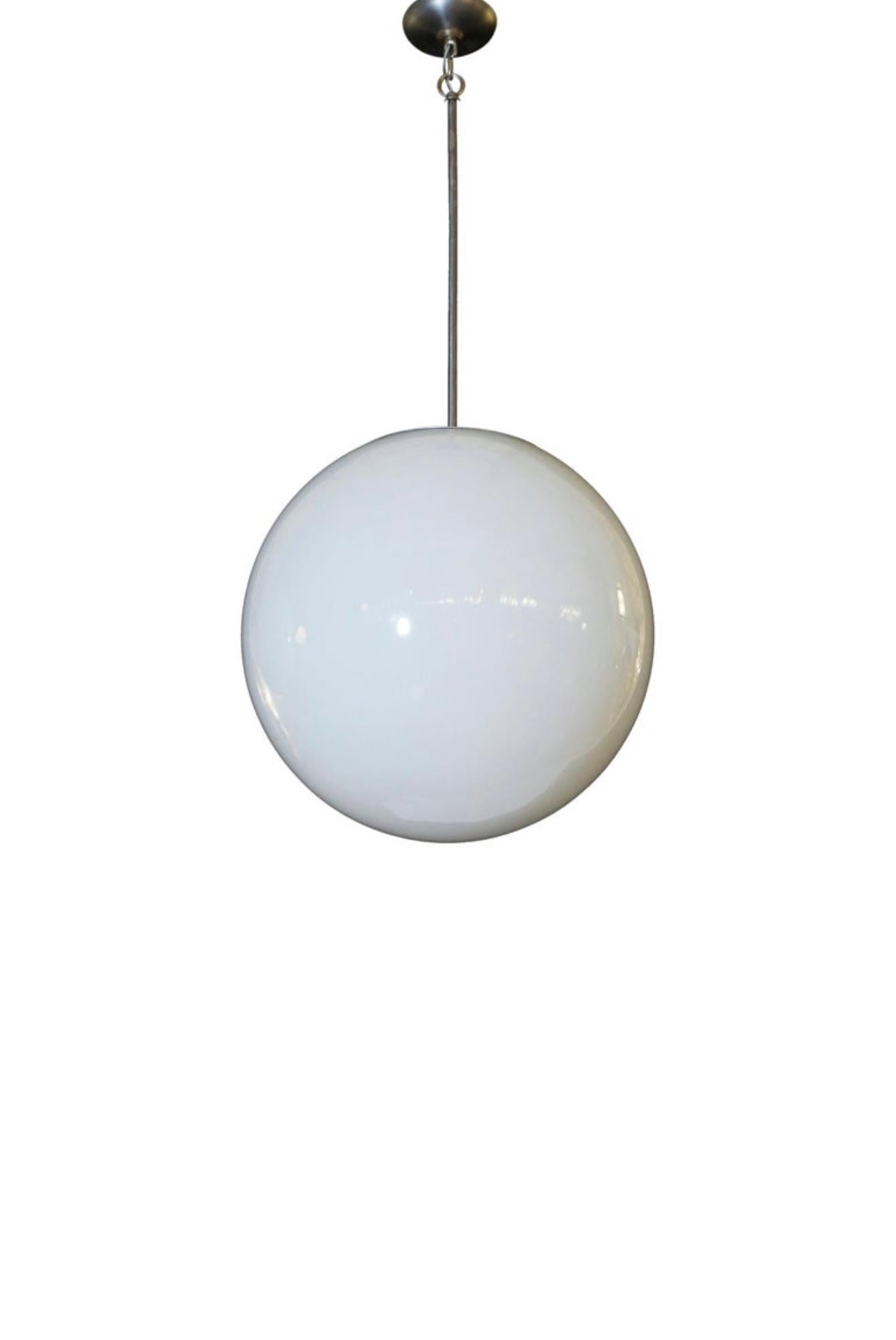 This Large Mid-Century Glass Globe Lamp is a stunning statement piece that embodies the elegance and sophistication of mid-century modern design. Featuring a beautifully round, frosted glass globe, the lamp casts a soft, warm glow, creating an