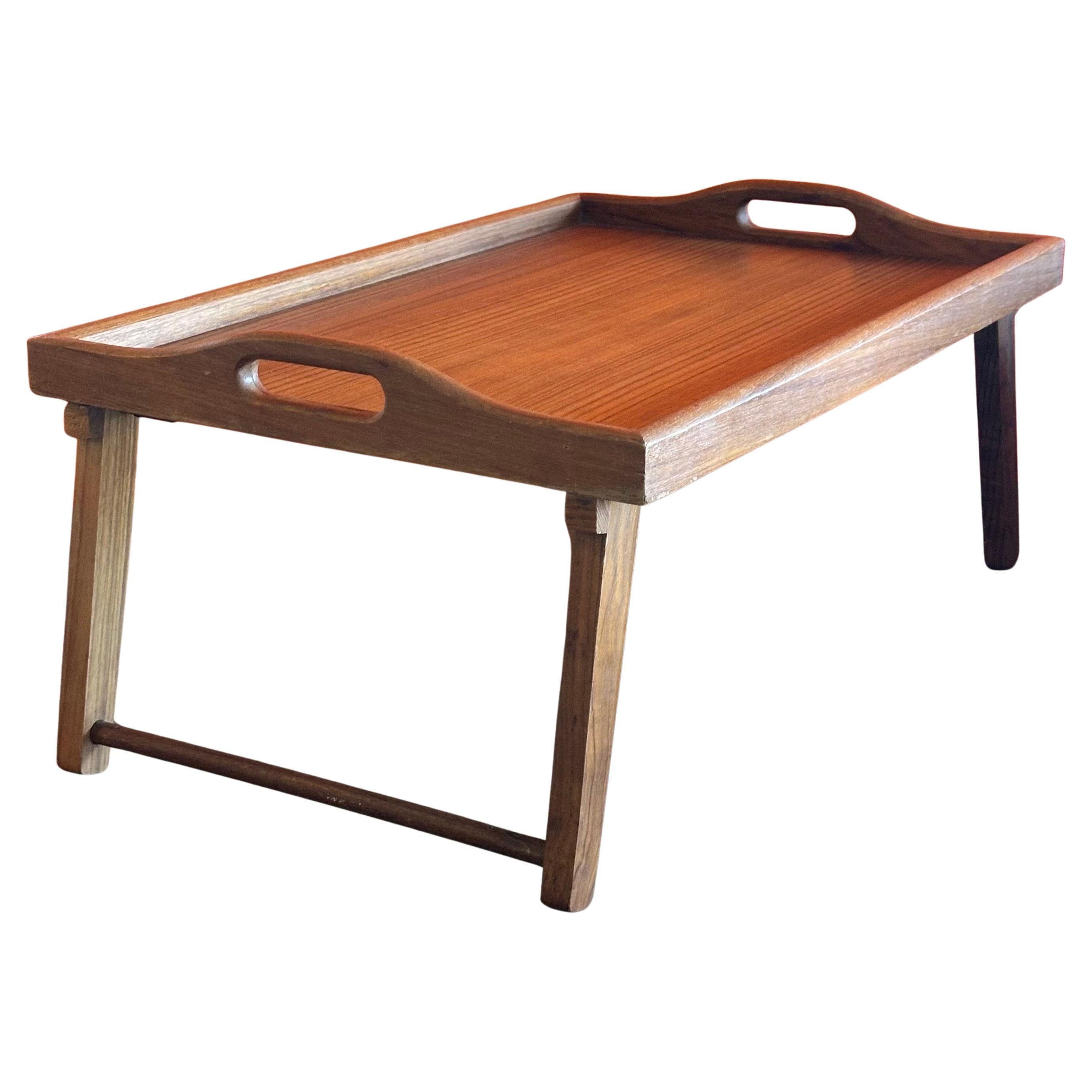 Versatile large MCM folding teak bed / breakfast tray, circa 1970s. The tray can be used for breakfast in bed with the two foldable legs or as a regular serving tray with the legs in the up position. The piece is in very good vintage condition and
