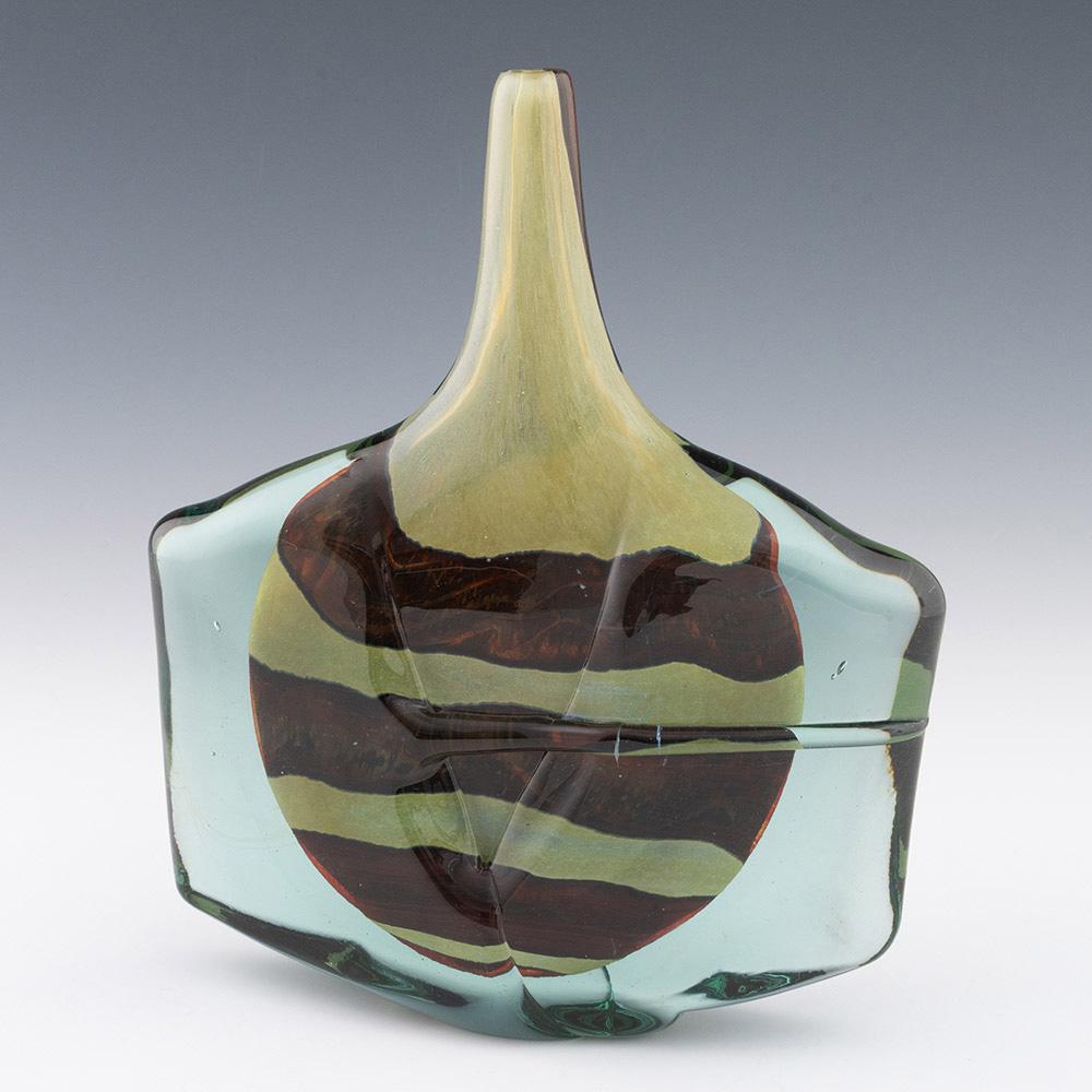 Heading :  Mdina vase – earthtones axe head 1982
Date : 1982
Origin : Mdina
Bowl Features : Axe head form with earthtones striped patttern
Marks : Signed Mdina 1982
Type : Lead
Size : 27.5cm height, 23.2cm width
Condition : Excellent
Restoration :