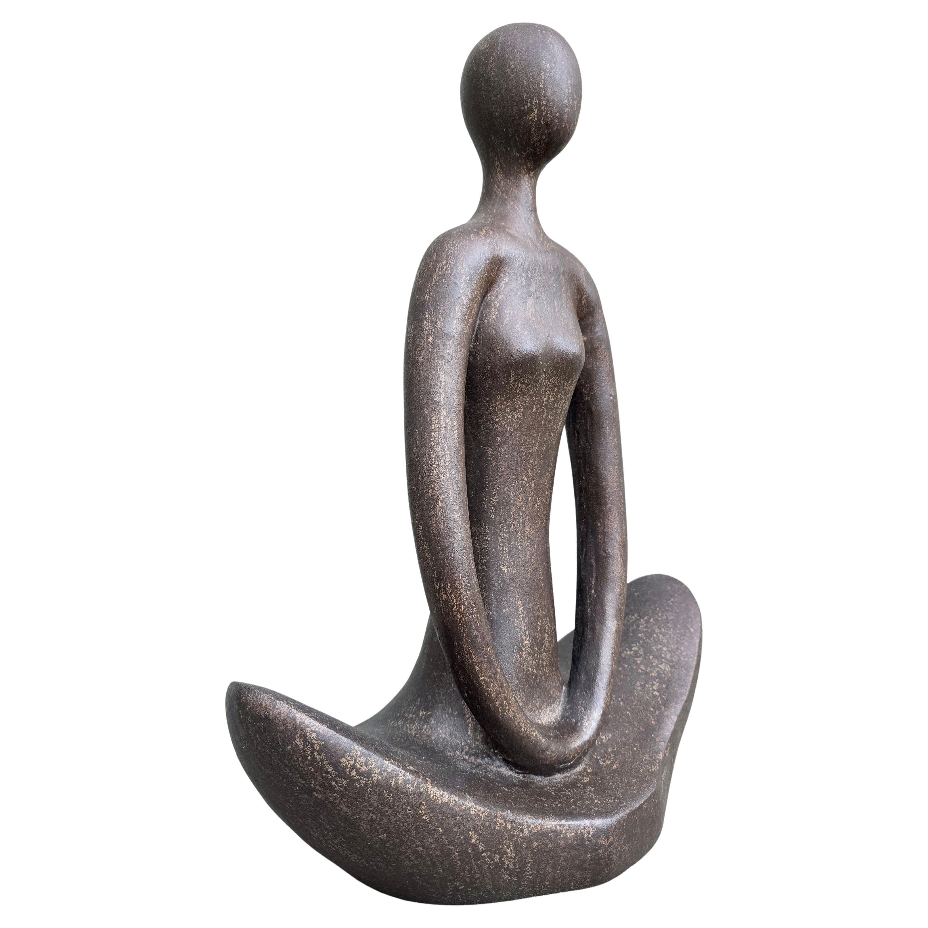 Large European mid-century ceramic sculpture. A serene abstract seated figure in a meditative yoga-inspired pose, with beautifully elongated lines and a calm, spiritual presence.

This elegant mid-century sculpture represents a seated human form