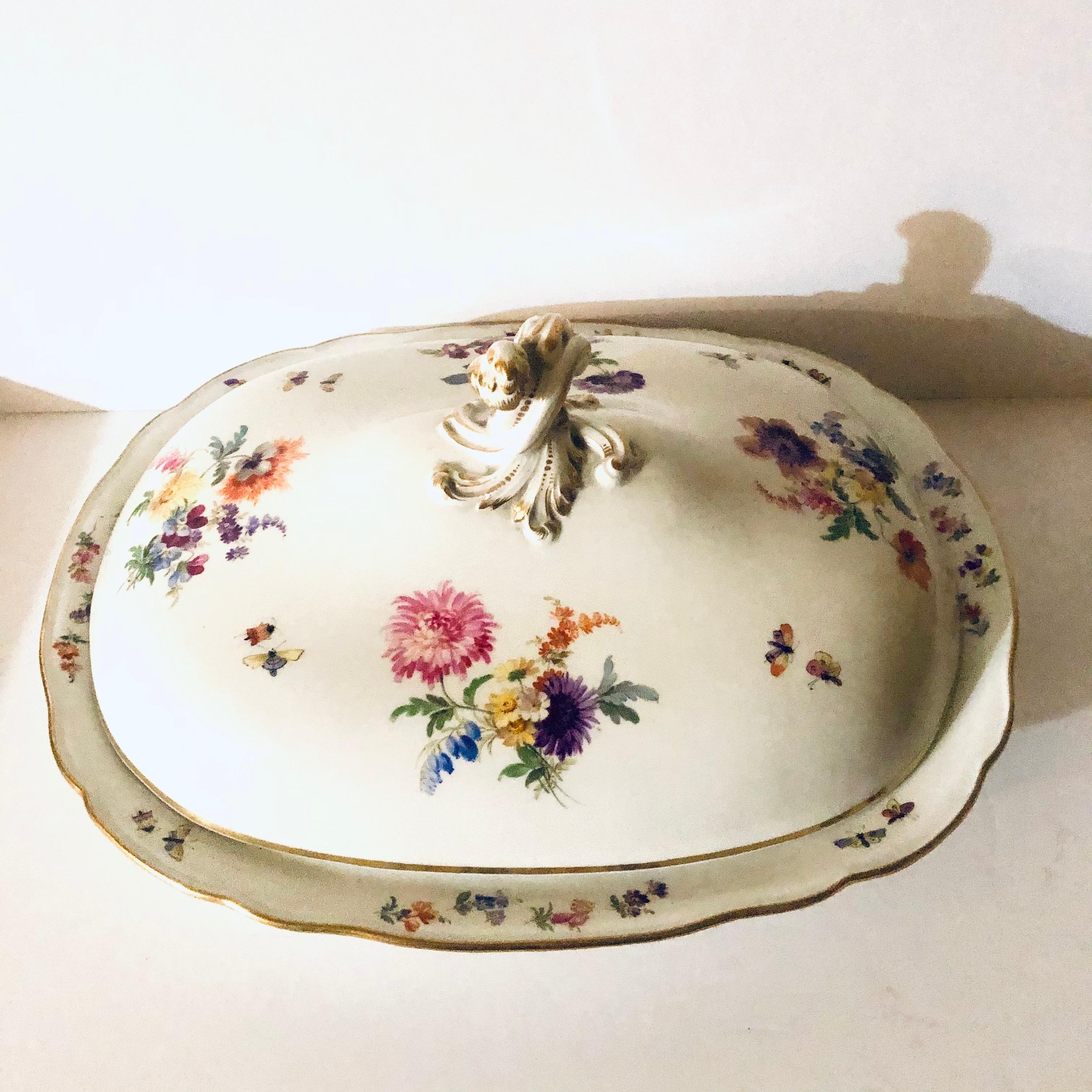 This is a fabulous large Meissen covered serving bowl in the New Brandenstein pattern with four beautiful different flower bouquets on top accented with whimsical insects. It was made in 1870s-1880s. The wonderful paintings of these flower bouquets