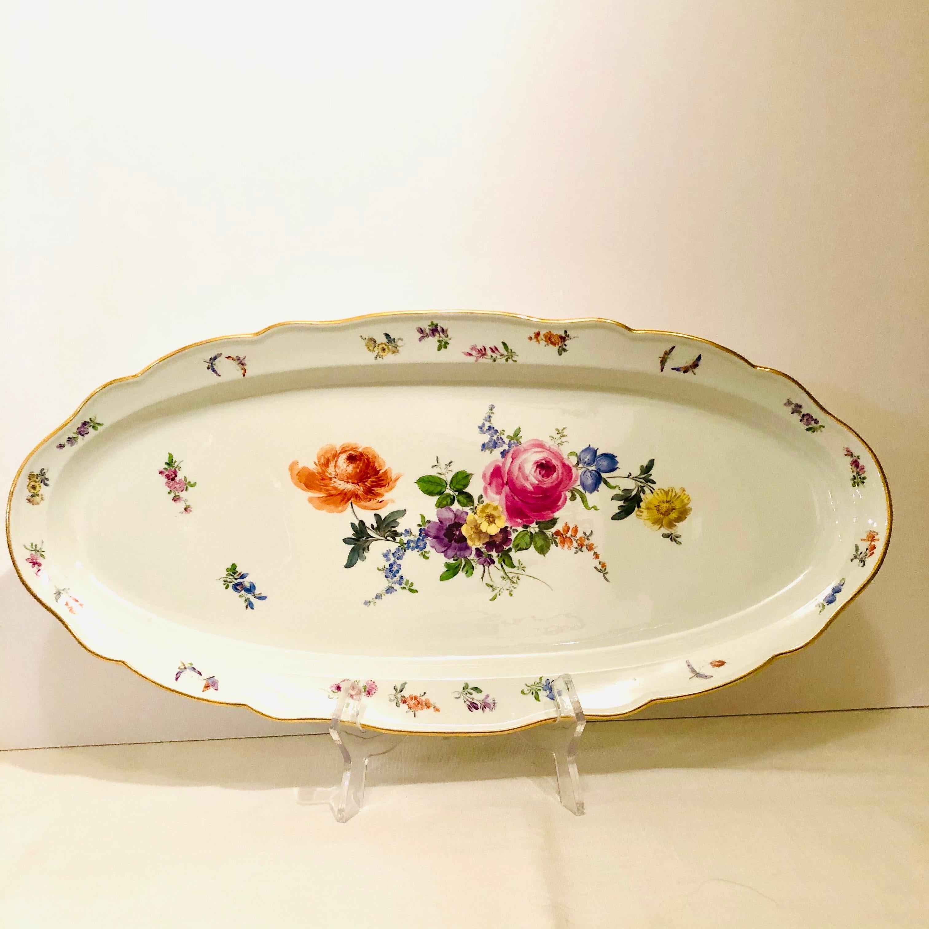 I am proud to offer you this large fabulous Meissen fish platter that is beautifully painted with a wonderful summer flower bouquet which has a pink rose, violets and other colorful summer flowers, and also butterflies in the background. When you