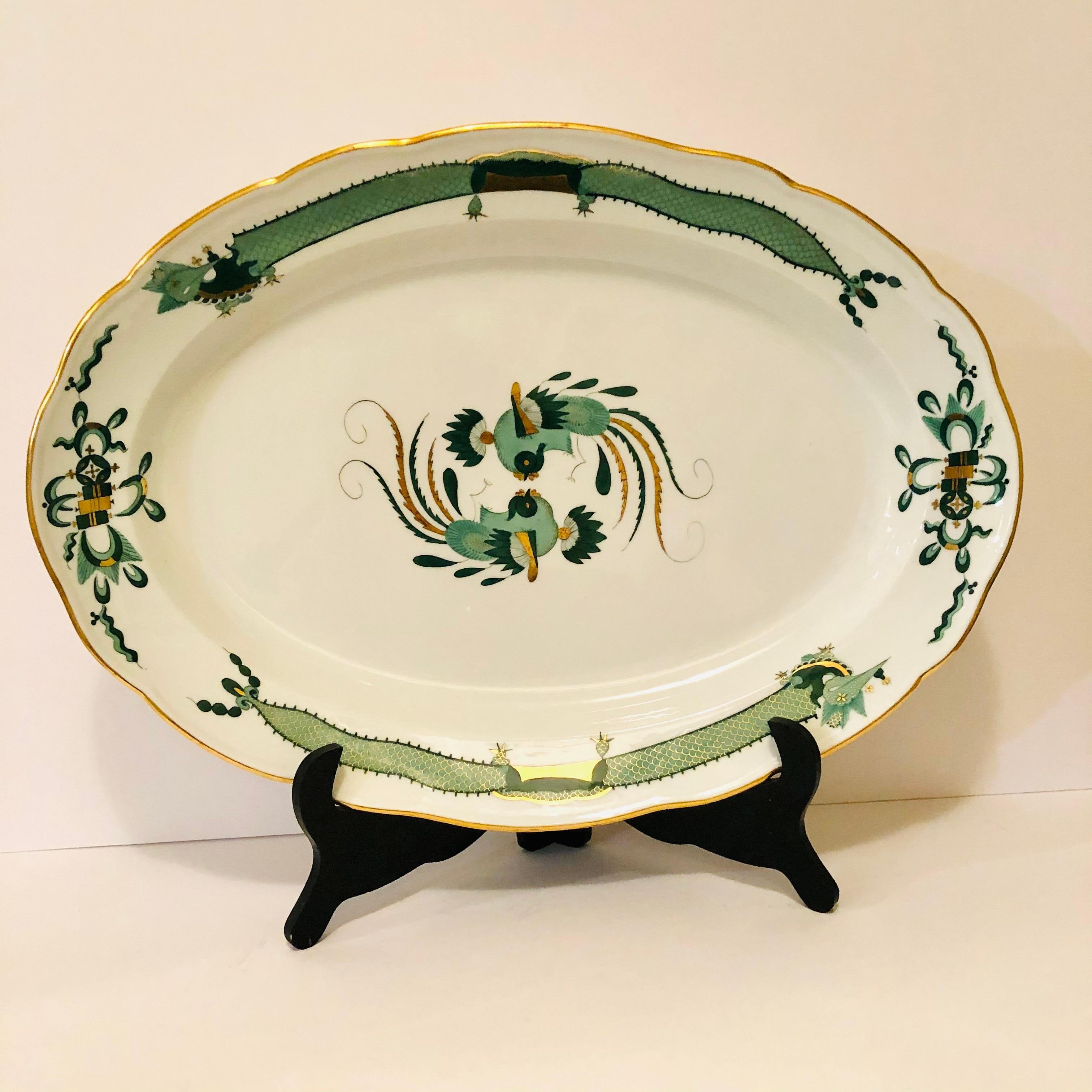 I want to offer you this beautiful Meissen green court dragon large platter dating back to the 1880s. The platter is 19 inches wide and 13.5 inches tall. You can see the detailed paintings of the dragons and the phoenix birds and the rich gold