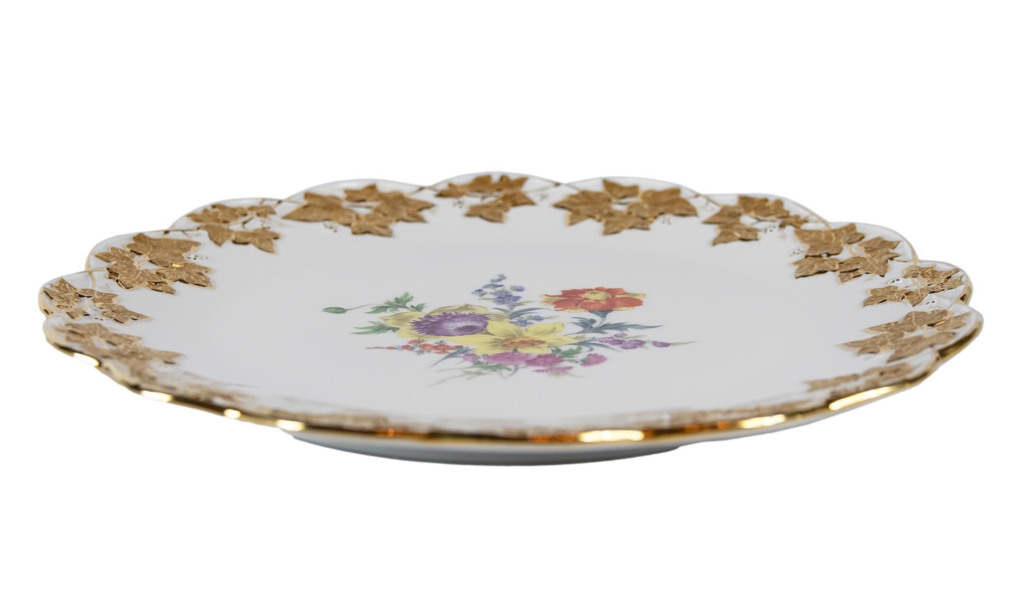 Large Meissen porcelain plate with hand painted floral motives and gold decor.